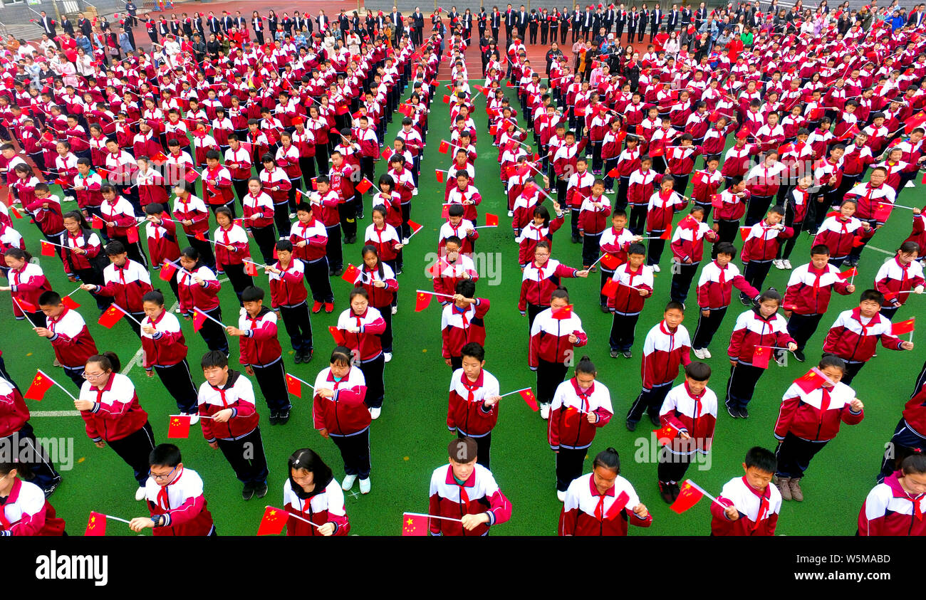 Thousands of primary school students gather at a football field to chant and praise mother country in Shenyang city, northeast China's Liaoning provin Stock Photo