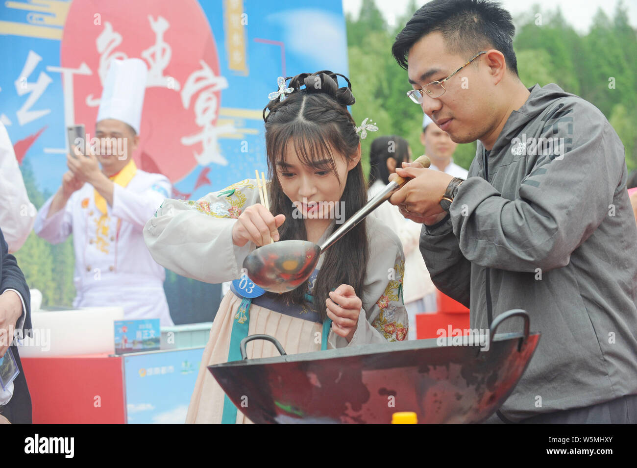 Tourists try out delicacies during the Most Popular Fish King Banquet in Xiantao city, central China's Hubei province, 27 April 2019.   The Most Popul Stock Photo