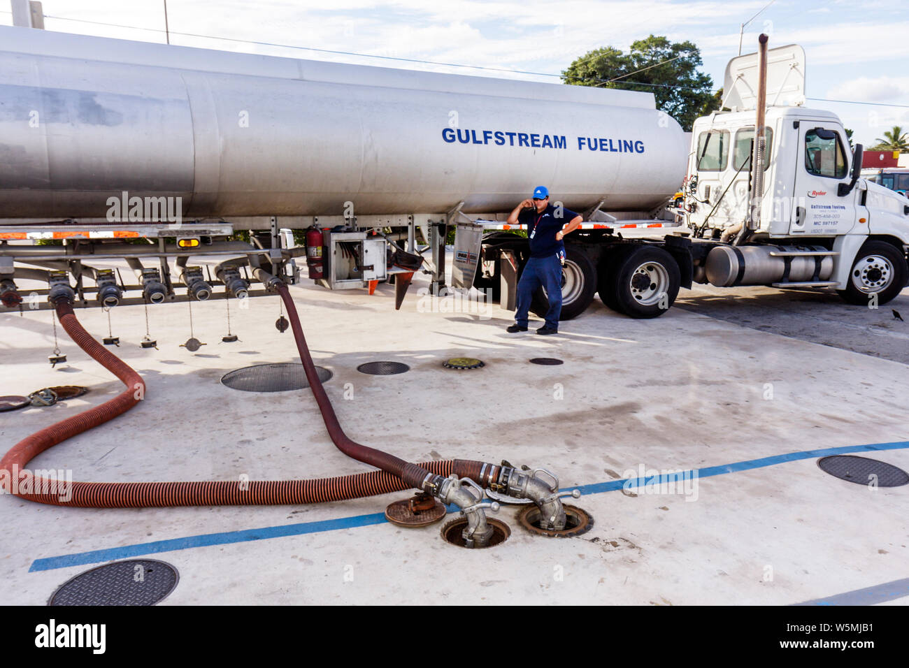 Miami Florida,Liberty City,gas,petrol,filling station,fuel,tank truck,road tanker,liquid load,transportation,distribution,man men male,driver,hose,FL0 Stock Photo