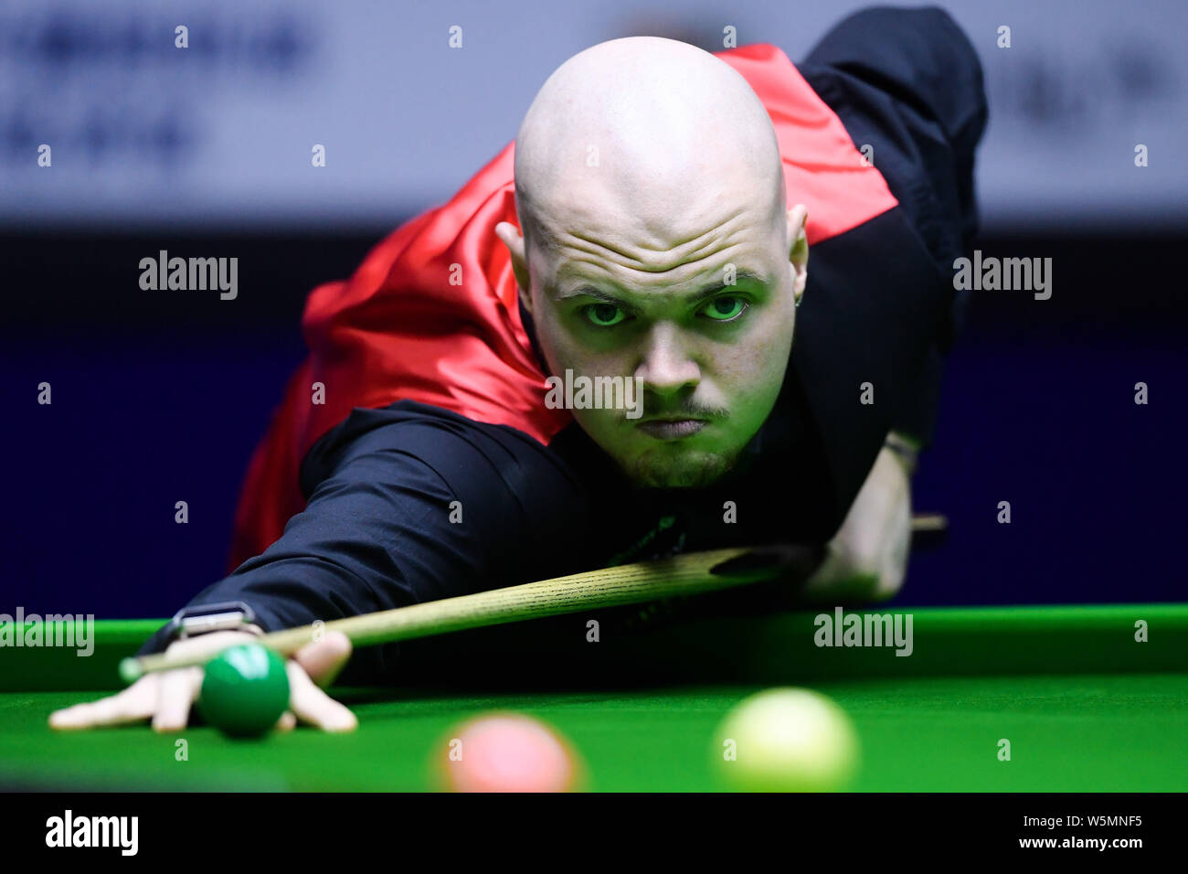 Elliot Slessor of England plays a shot to Stuart Bingham of England in the first round match during the Xingpai Group 2019 World Snooker China Open in Stock Photo