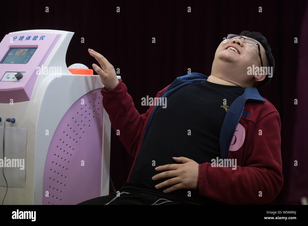 The face of an expectant father contorts as he experiences the pain of ...