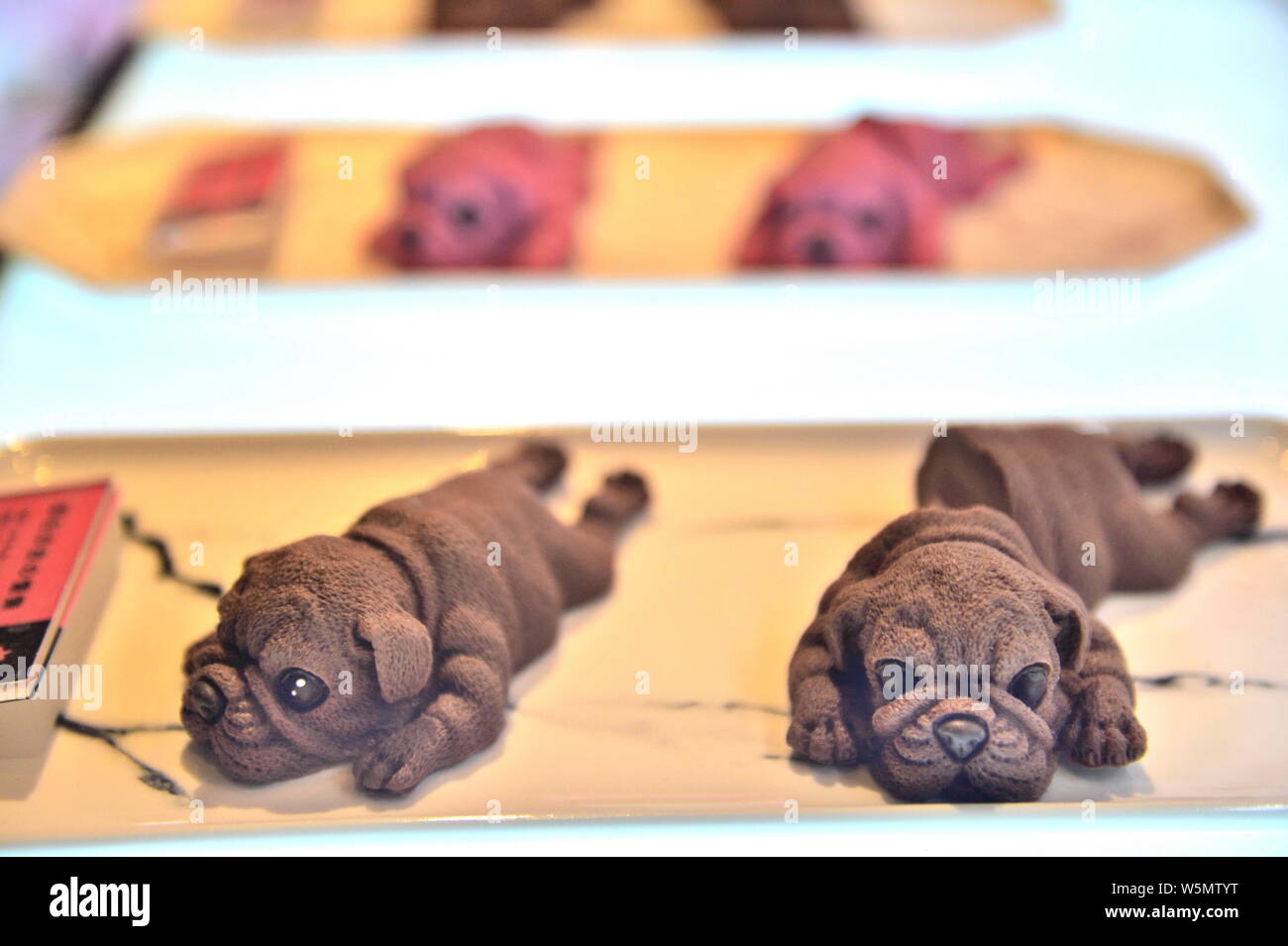 FILE--Realistic dog cakes are for sale at a bakery in Tianjin, China, 23  November 2018. Puppy-shaped mousse cakes first became popular in Kaohsiun  Stock Photo - Alamy