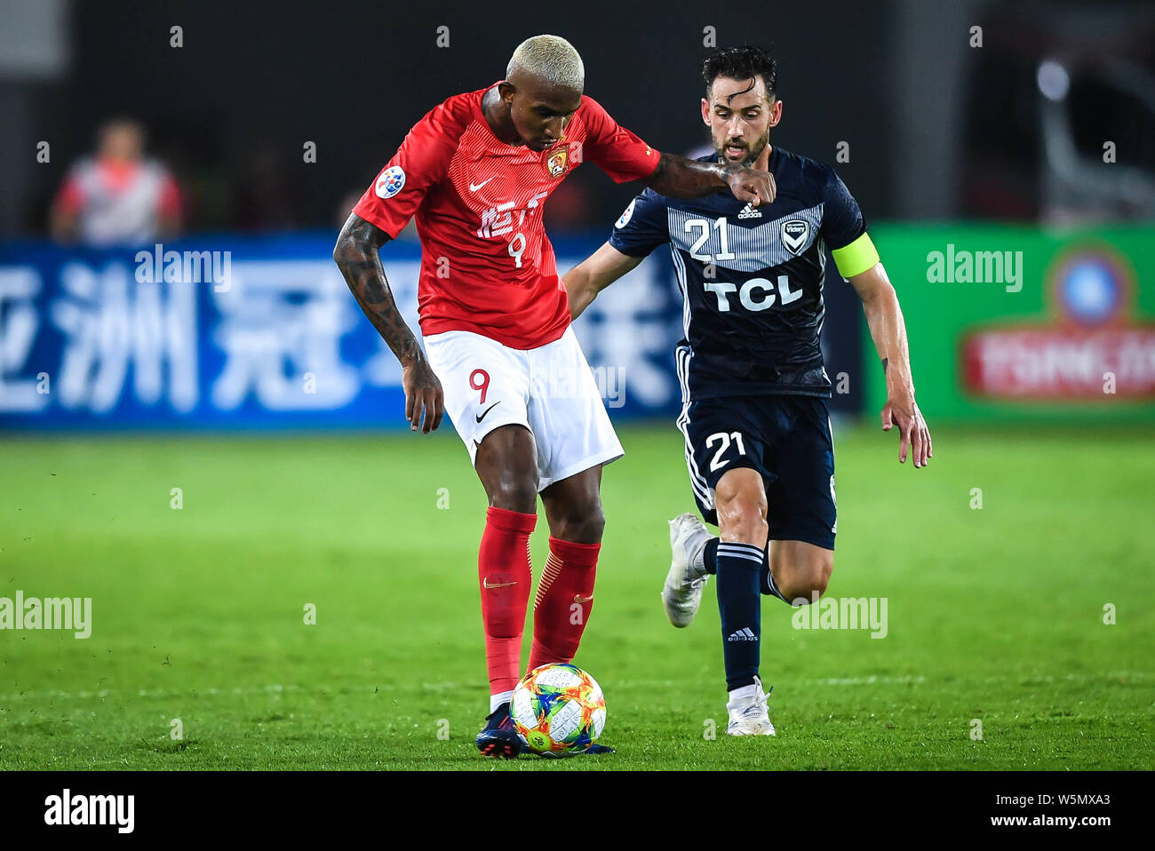 Brazilian soccer player Anderson Souza Conceicao, known as Anderson Talisca or simply Talisca, left, of China's Guangzhou Evergrande Taobao F.C., drib Stock Photo