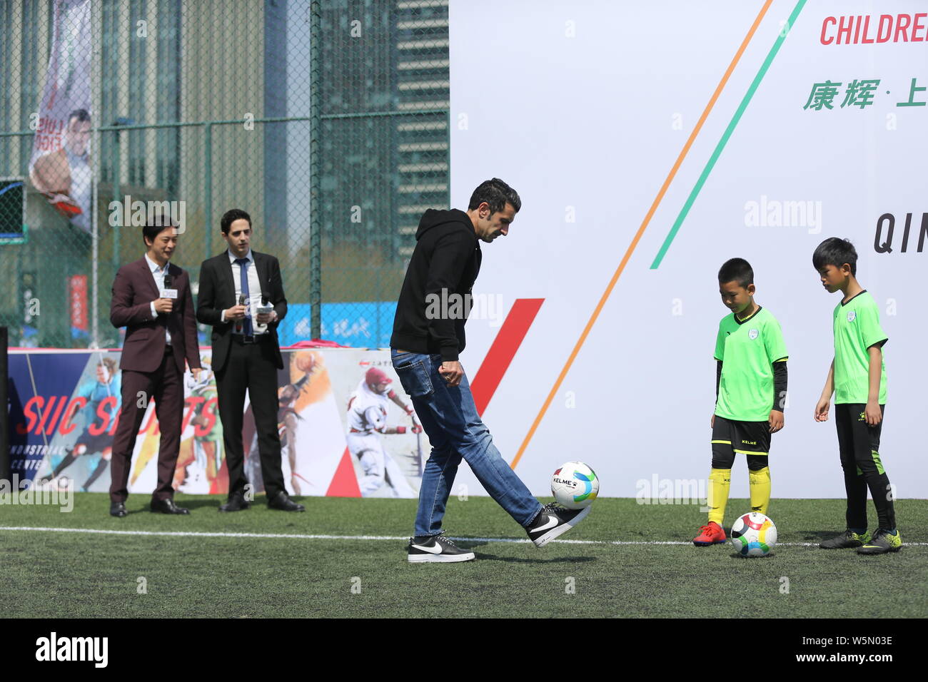 Retired Portuguese football player Luis Figo attends the opening ceremony for SIIC Cup 2019 Qingdao Children's Football Elite League in Qingdao city, Stock Photo