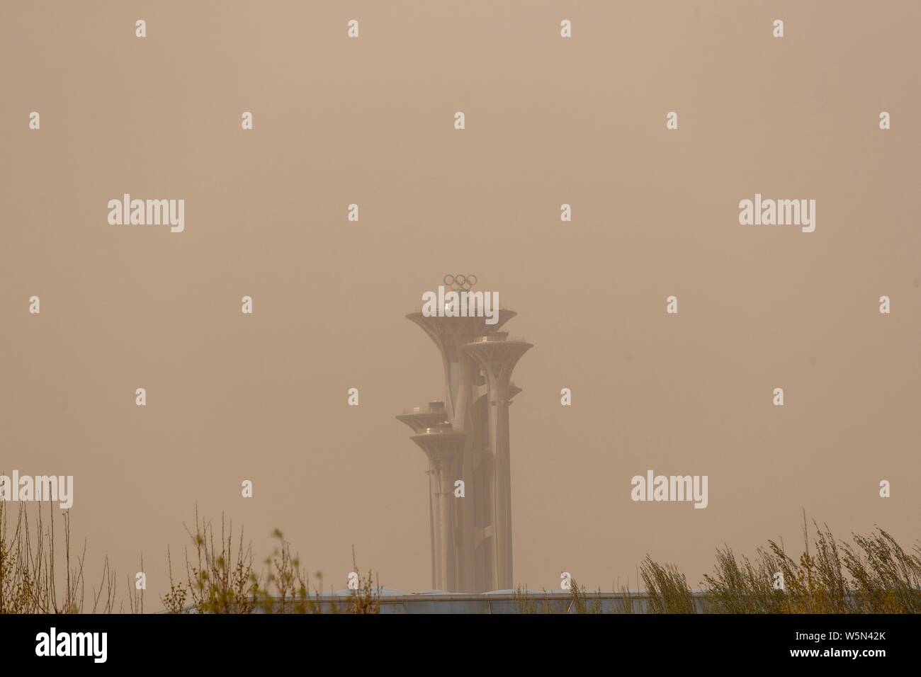 High-rising buildings are seen vaguely in heavy dust in Beijing, China ...