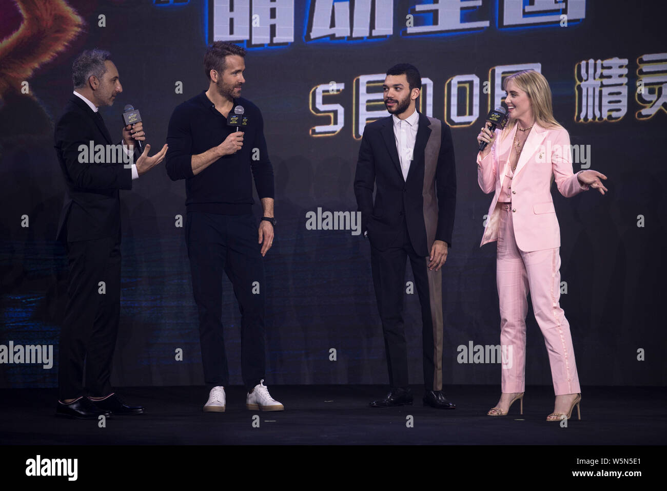 (From right) American actress Kathryn Newton, actor Justice Smith, Canadian-American actor Ryan Reynolds, and American film director Rob Letterman att Stock Photo