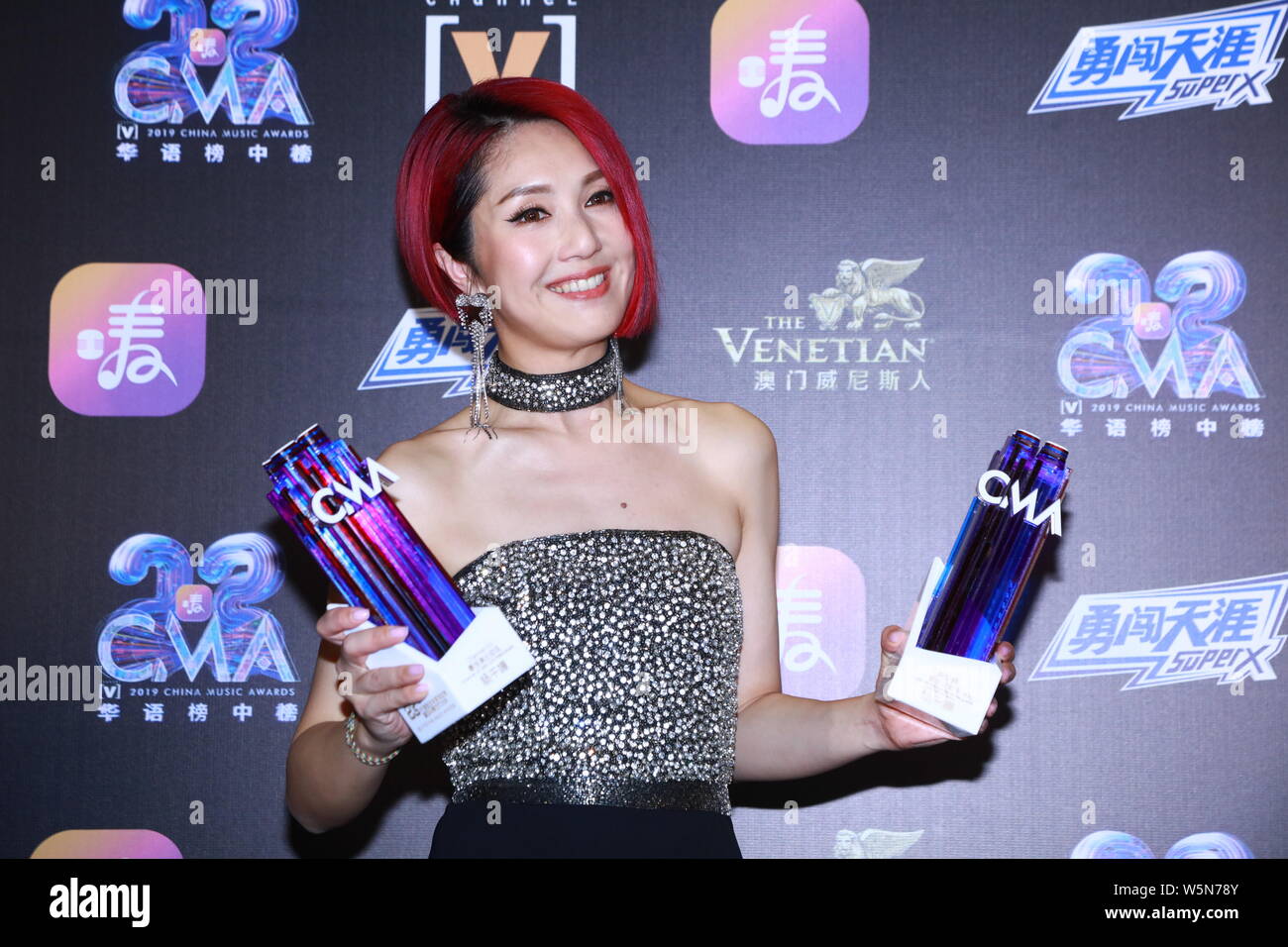 Hong Kong singer and actress Miriam Yeung poses with her trophies after