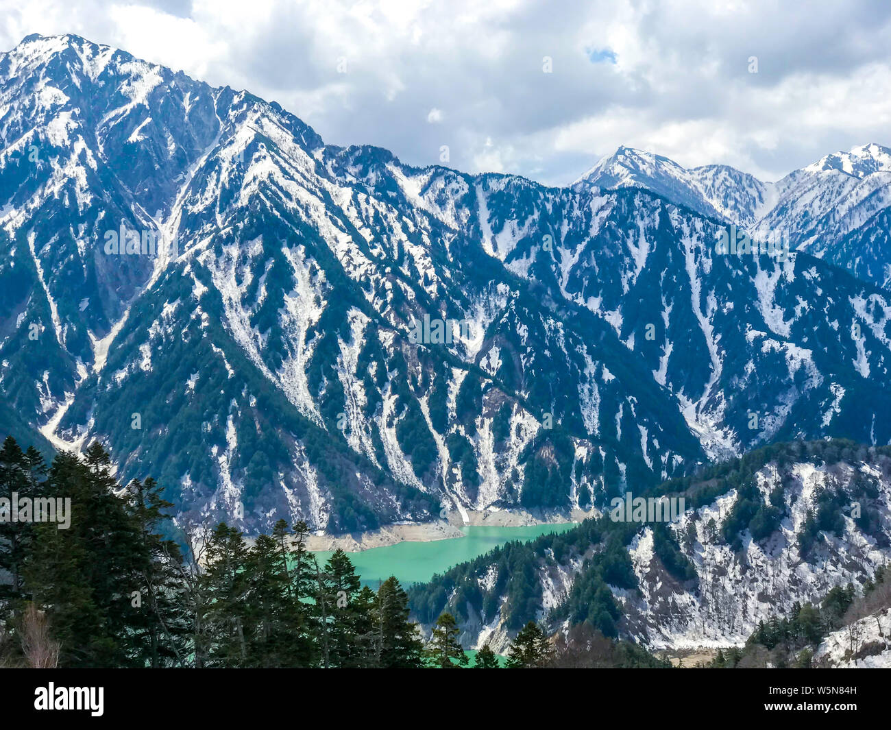 Beautiful snow mountain view with blue sky on Tateyama Kurobe alpine route, Japanese alps in Japan. Stock Photo