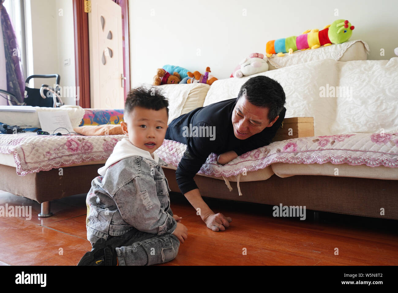 43-year-old man Song Xuewen, the first victim of the nuclear radiation case in China, is pictured with his son at his home in Jiaohe county, Jilin cit Stock Photo