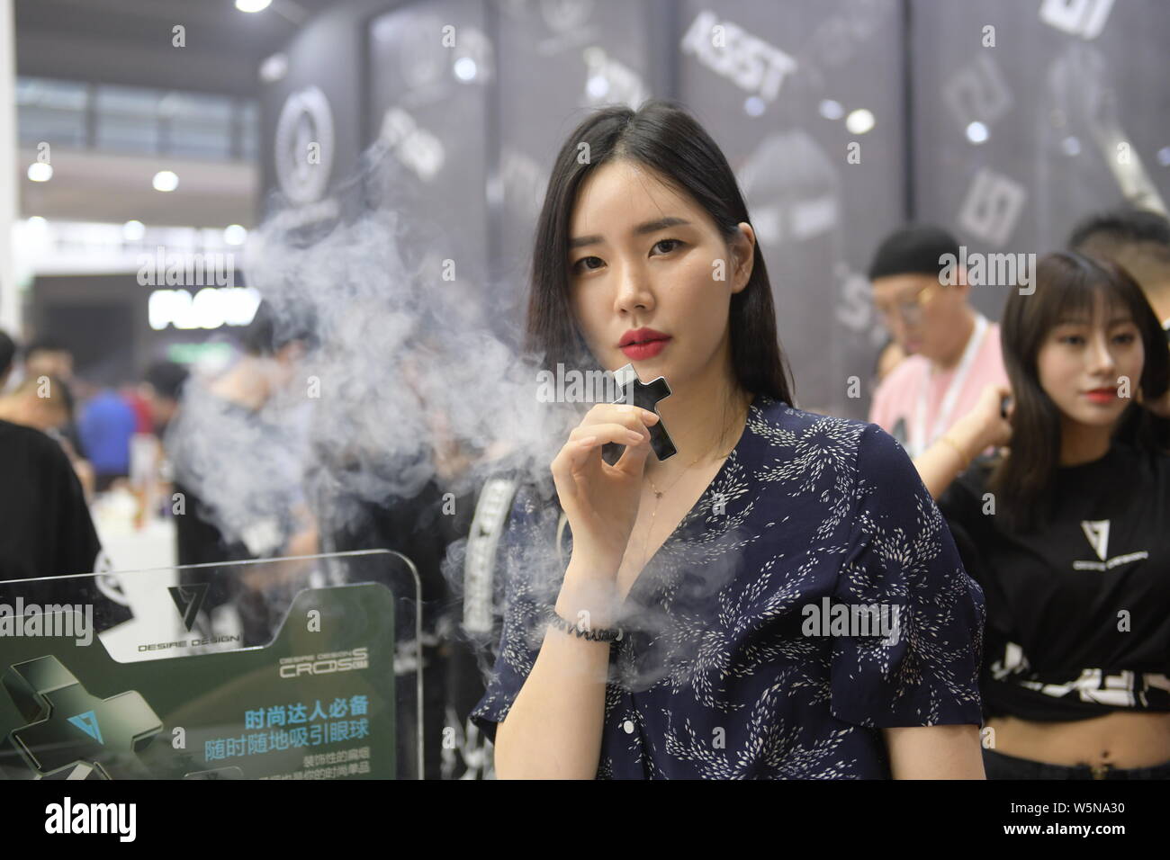 A visitor tries out an e-cigarette during the 2019 IECIE Shenzhen eCig Expo  at Shenzhen Convention & Exhibition Center in Shenzhen city, south China's  Stock Photo - Alamy
