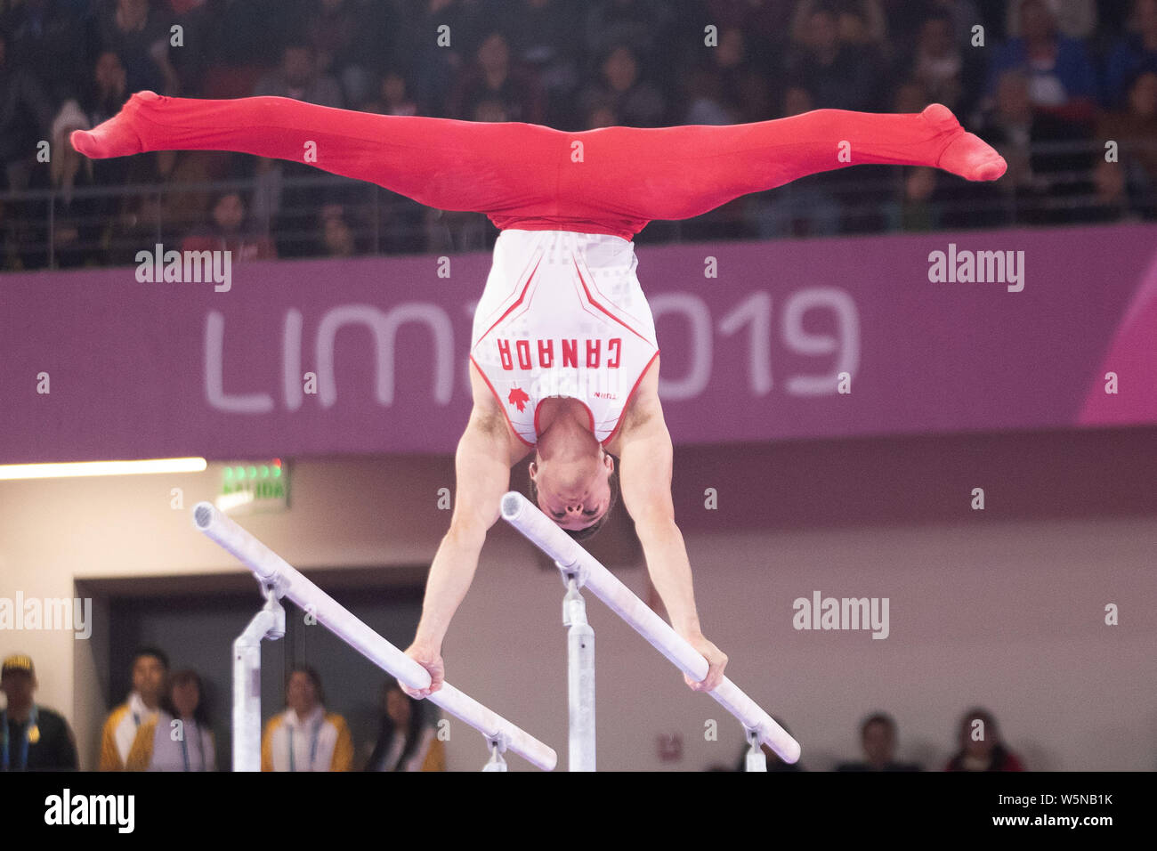 Lima, Peru. 28th July, 2019. Rene Cournoyer (#83) of Canada performs on the parallel bars during the Pan American Games Artistic Gymnastics, Men's Team Qualification and Final at Polideportivo Villa el Salvador in Lima, Peru. Daniel Lea/CSM/Alamy Live News Stock Photo
