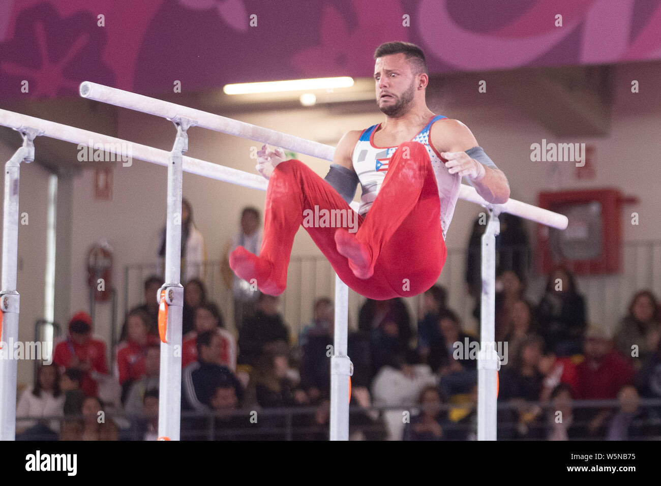 Lima, Peru. 28th July, 2019. Jose Lopez (#117) of Peru dismounts from the parallel bars during the Pan American Games Artistic Gymnastics, Men's Team Qualification and Final at Polideportivo Villa el Salvador in Lima, Peru. Daniel Lea/CSM/Alamy Live News Stock Photo