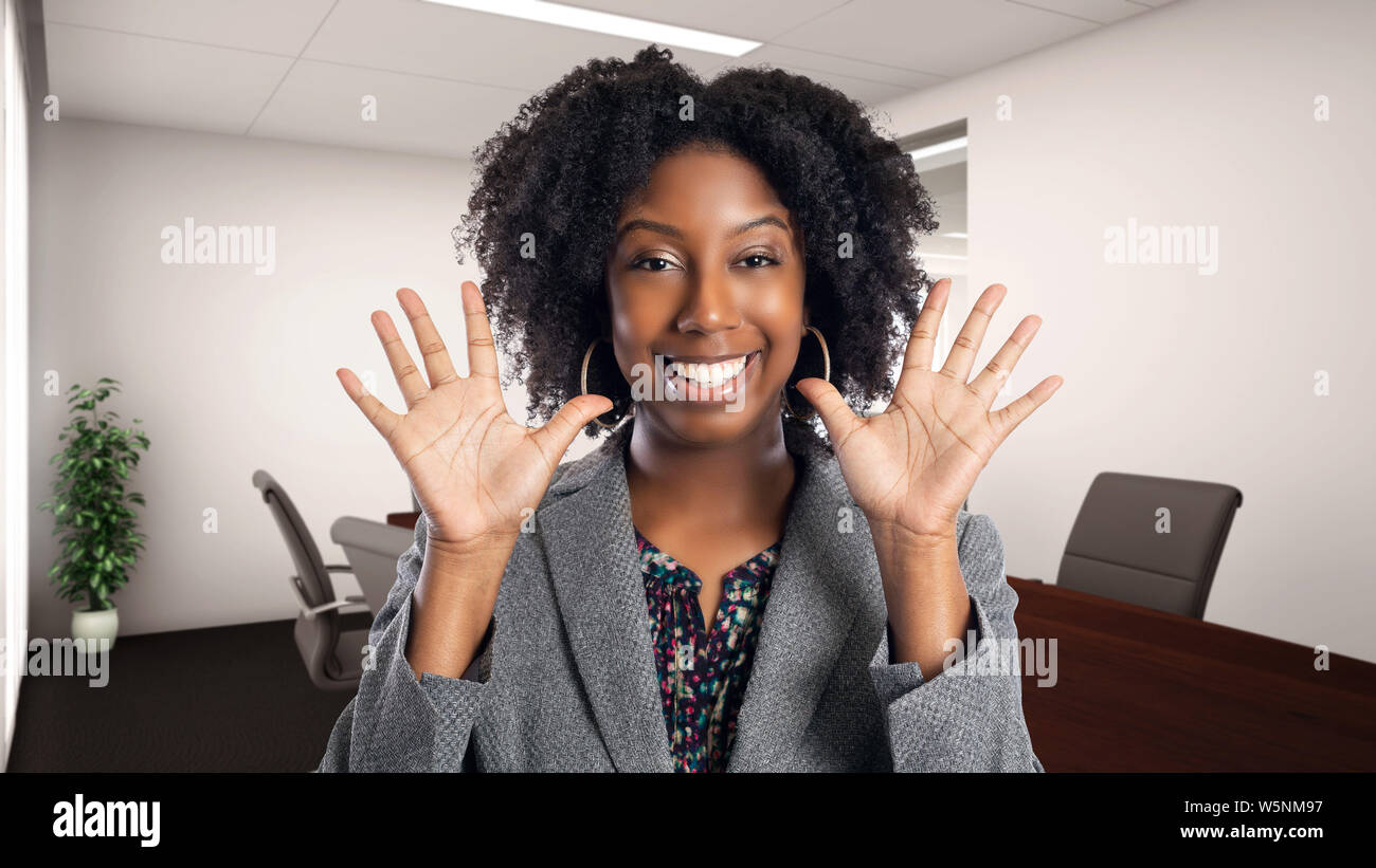 Black African American businesswoman in an office smiling happy. She is ...