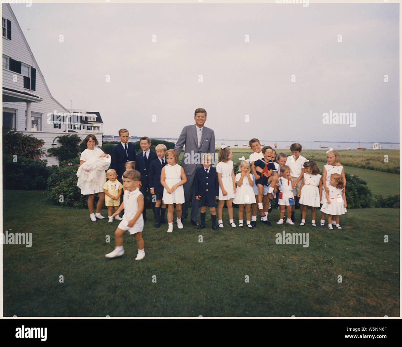 Hyannisport Weekend- President Kennedy with children; Scope and content:  Hyannisport Weekend- President Kennedy with children. Kathleen Kennedy ( holding Christopher Kennedy ) Edward Kennedy Jr.,Joseph P. Kennedy II, Kara Kennedy, Robert F. Kennedy Jr., David Kennedy, Caroline Kennedy, President Kennedy, Michael Kennedy, Courtney Kennedy, Kerry Kennedy, Bobby Shriver ( holding Timothy Shriver ), Maria Shriver, Steve Smith Jr., Willie Smith, Christopher Lawford, Victoria Lawford, Sidney Lawford, Robin Lawford (in foreground- John F. Kennedy Jr.). Hyannisport, MA, Kennedy Compound Stock Photo