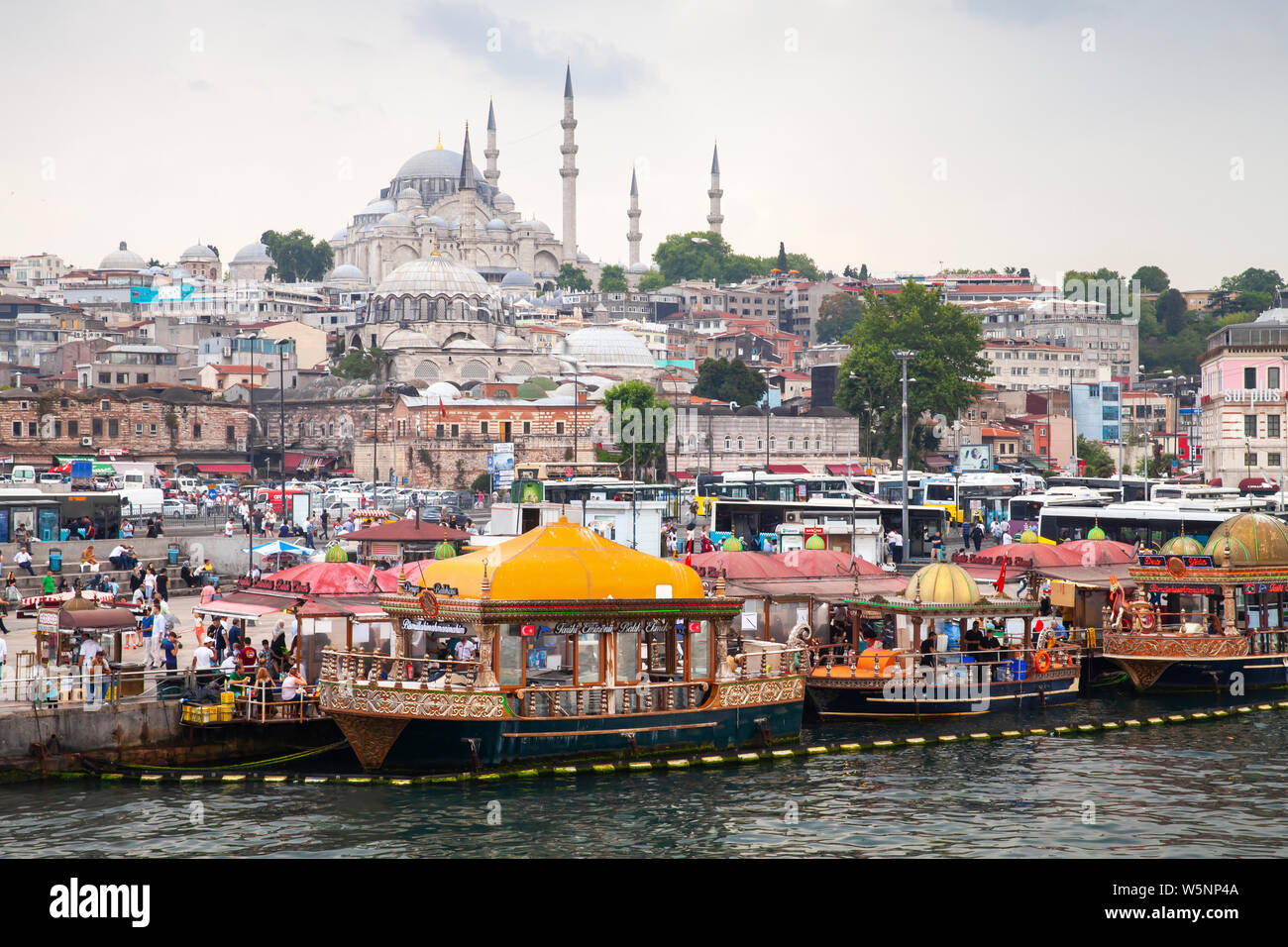 Istanbul, Turkey - June 26, 2016: Istanbul Cityscape, Eminonu former district. People are on the coast of Golden Horn, Suleymaniye Mosque is on a back Stock Photo