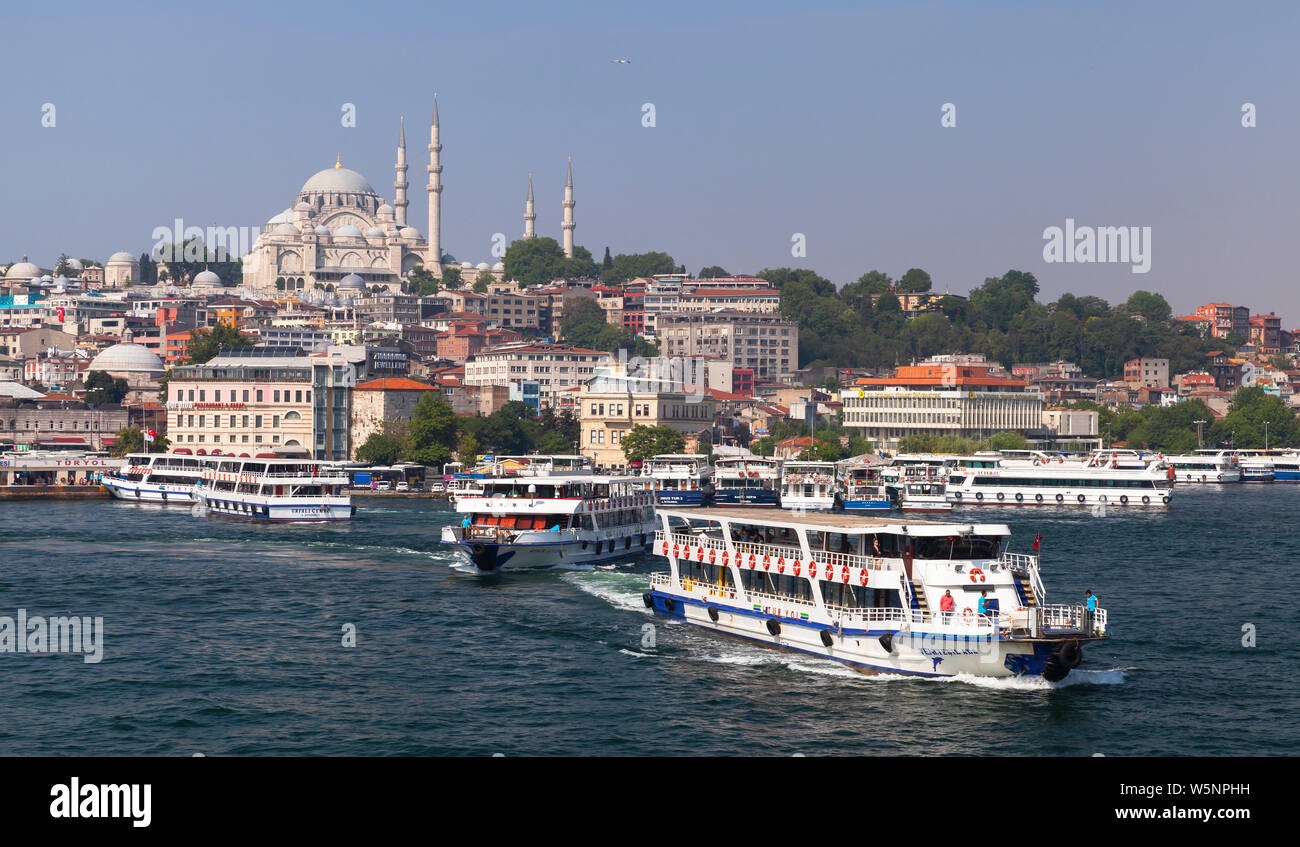 Istanbul, Turkey - July 1, 2016: Istanbul landscape. Passenger boats are at Golden Horn, Suleymaniye Mosque is on a background Stock Photo