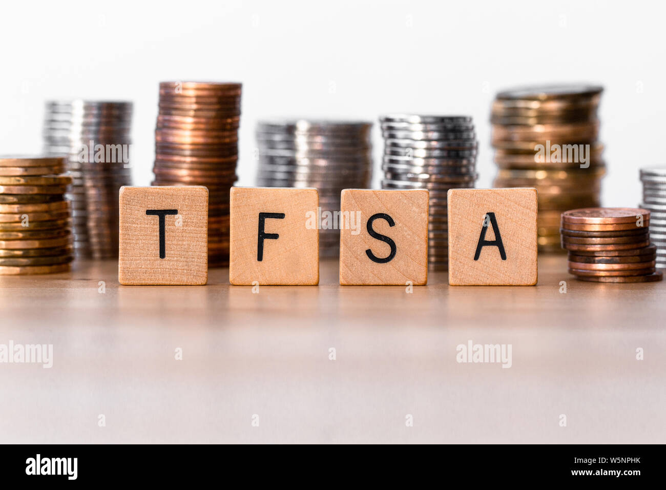 TFSA (Tax Free Saving Accounts) sign with coins in the background Stock