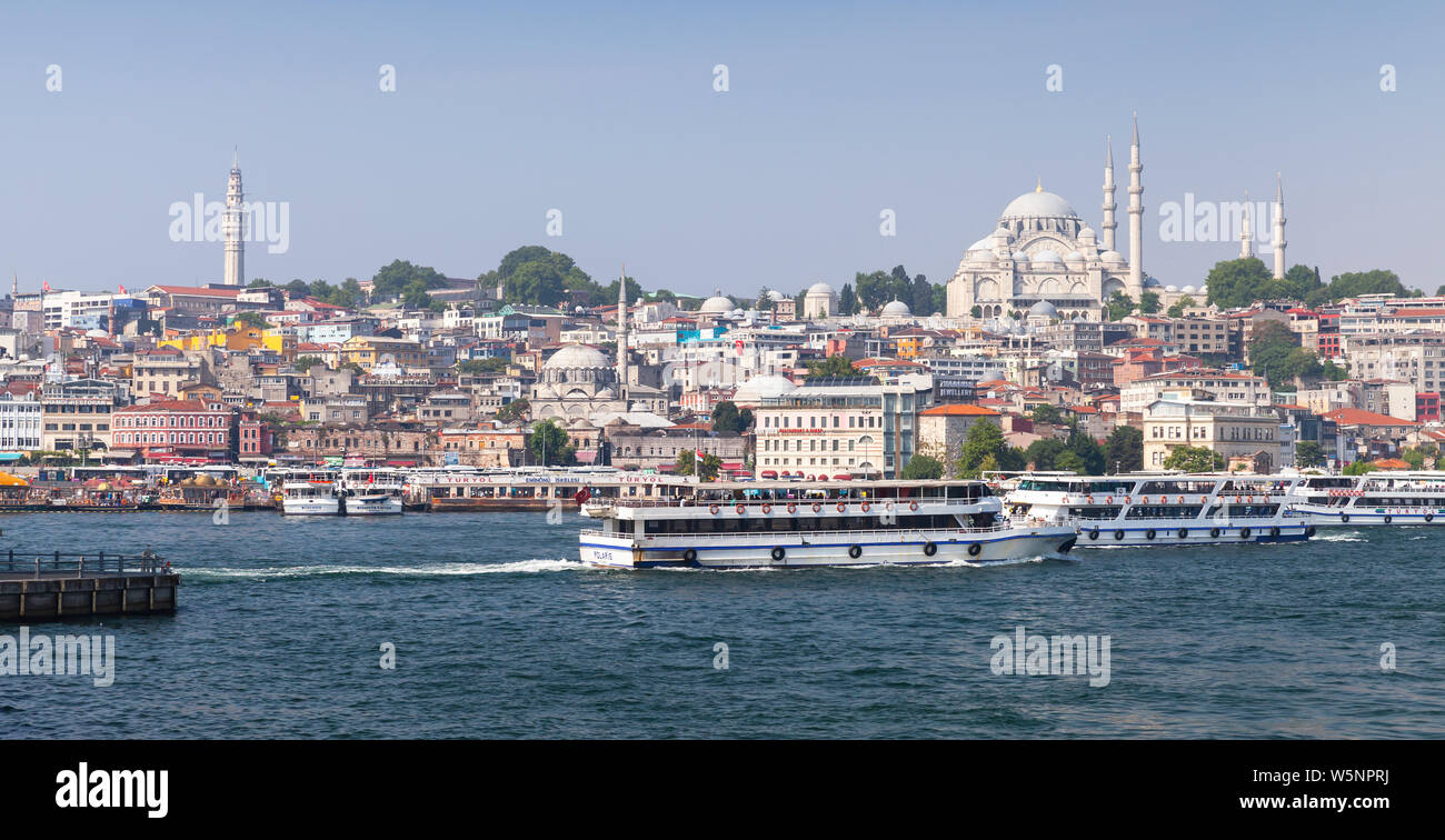 Istanbul, Turkey - July 1, 2016: Istanbul landscape, Eminonu district. Passenger boats are at Golden Horn, Suleymaniye Mosque is on a background Stock Photo