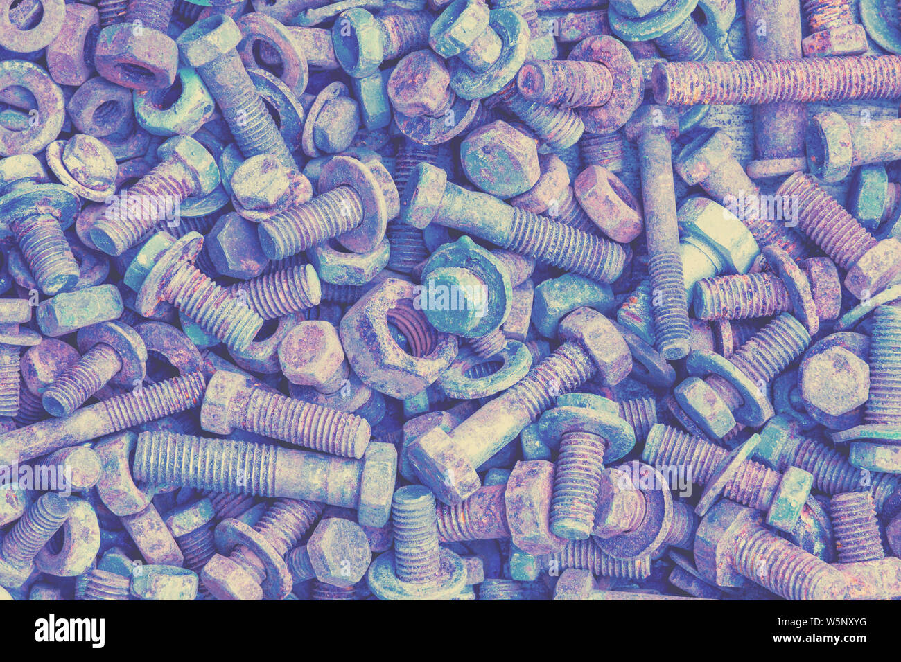 Abstract grunge metal background from old rusty bolts, screws, nuts, and washers Stock Photo