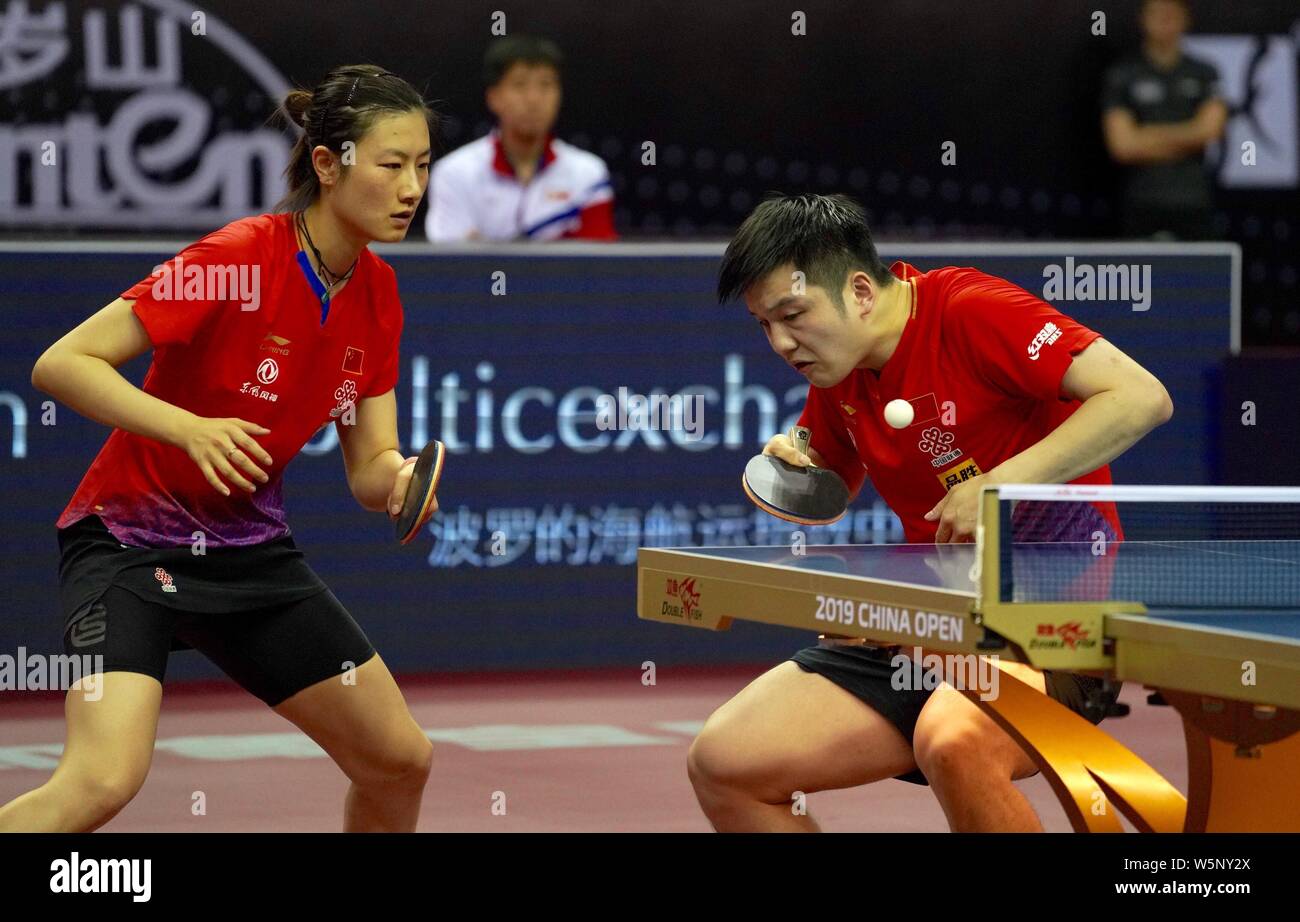 Fan Zhendong and Ding Ning of China return a shot to An Ji Song and Kim ...