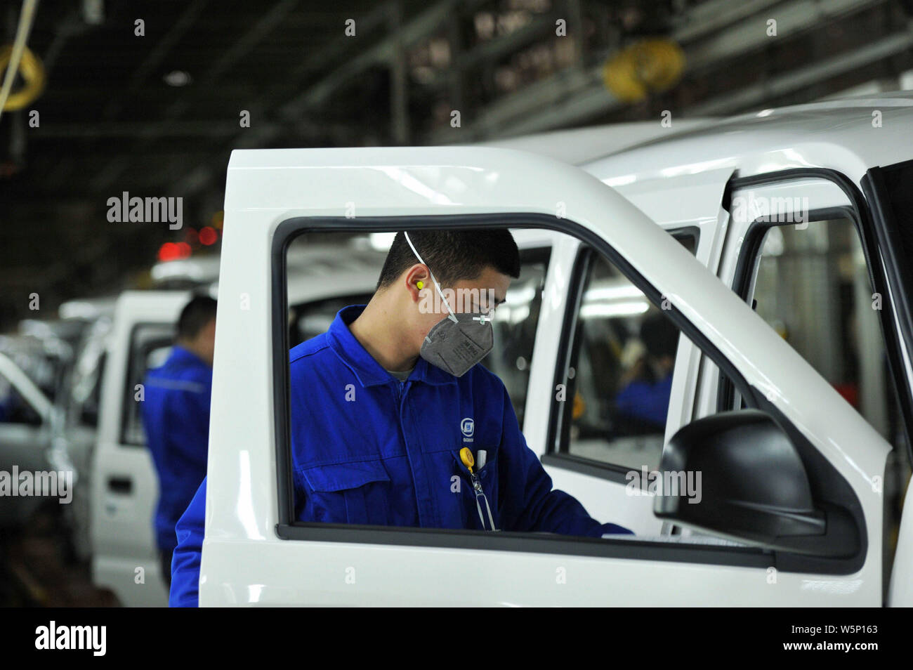--FILE--A Chinese worker assembles cars on the assembly line at the ...