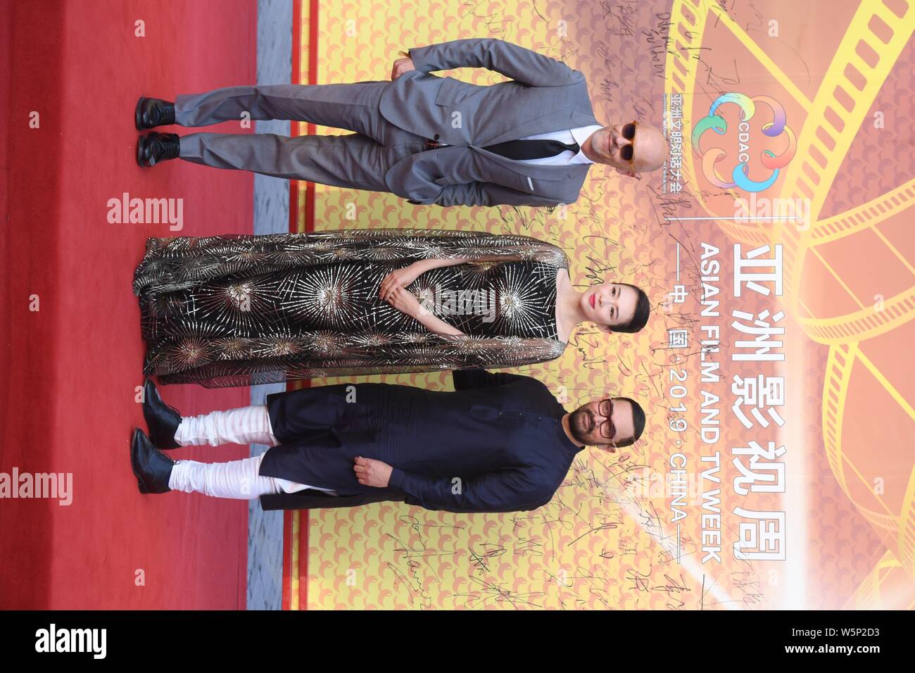 Chinese actress Zhang Ziyi, center, and Indian actor Aamir Khan, right, pose as they arrive on the red carpet for the launch ceremony of Asian Film an Stock Photo