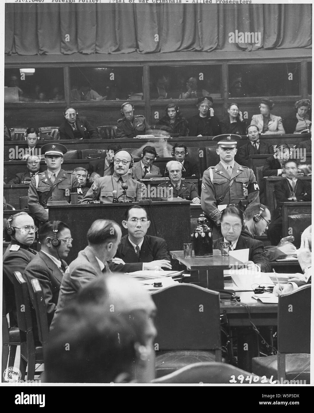 Japanese War Crimes Trials. Manila; Scope and content:  TOJO TAKES THE STAND. - Hideki Tojo, former Japanese General Premier and War Minister, from December 2, 1941 to July 1944, takes the stand for the first time during the International Tribunal trials, Tokyo, Japan. He is testifying in his own behalf during the defense phase of the trials. Tojo is surrounded by the Tribunal's staff. Stock Photo