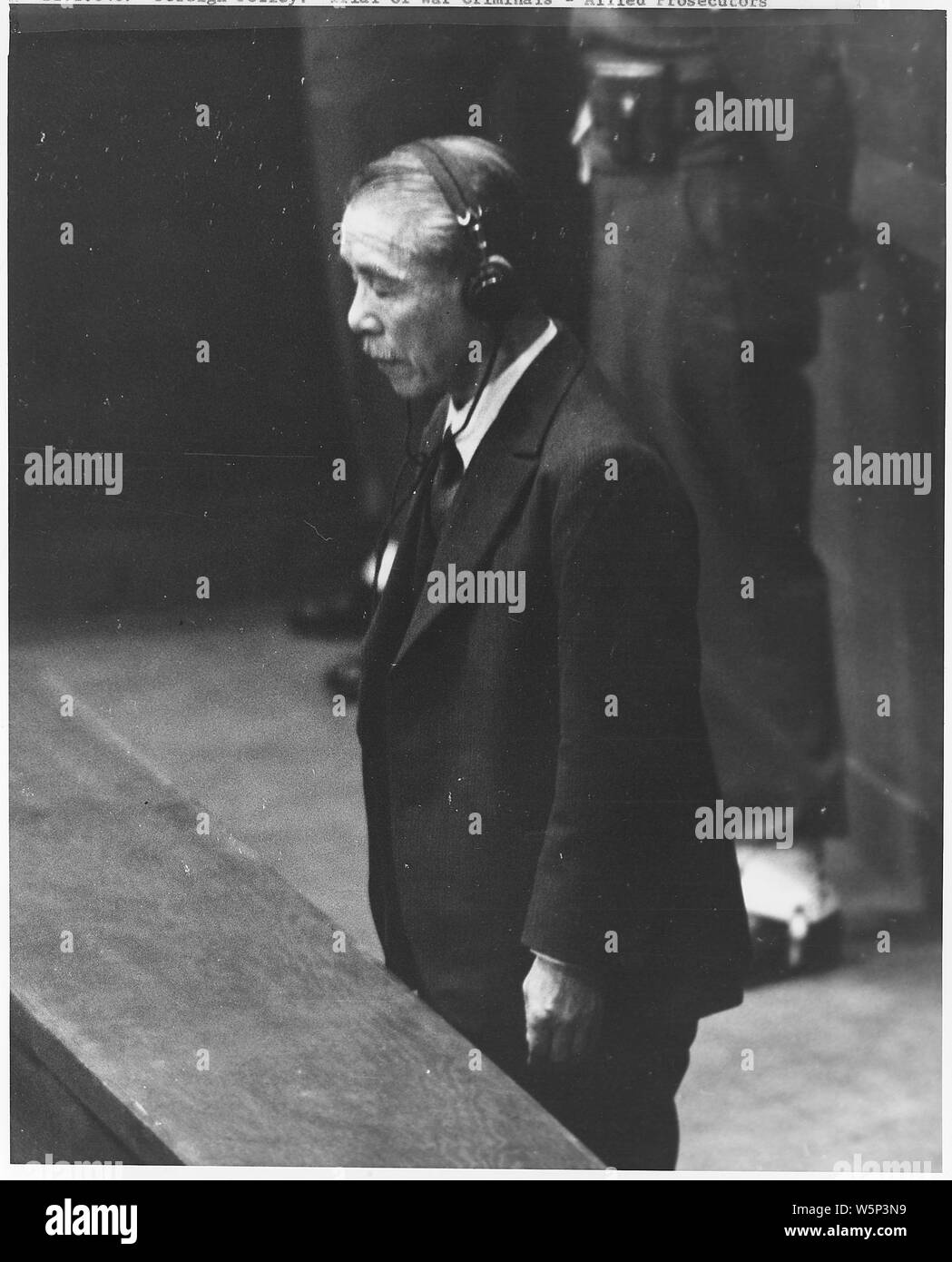 Japanese War Crimes Trials. Manila; Scope and content:  Koki Hirota listens to death sentence read by Sir William Webb (Australia) (not shown), President of the International Military Tribunal for the Far East. Hirota, age 70, was Prime Minister from March 1936, to February 1937 and Foreign Minister under Saito, Okada and Konoye. November 12, 1948. Stock Photo