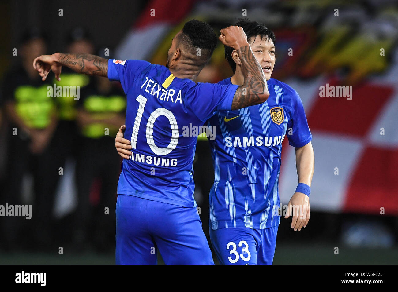 Brazilian football player Alex Teixeira, left, of Jiangsu Suning F.C. celebrates with Wang Song after scoring a goal against Guangzhou Evergrande Taob Stock Photo