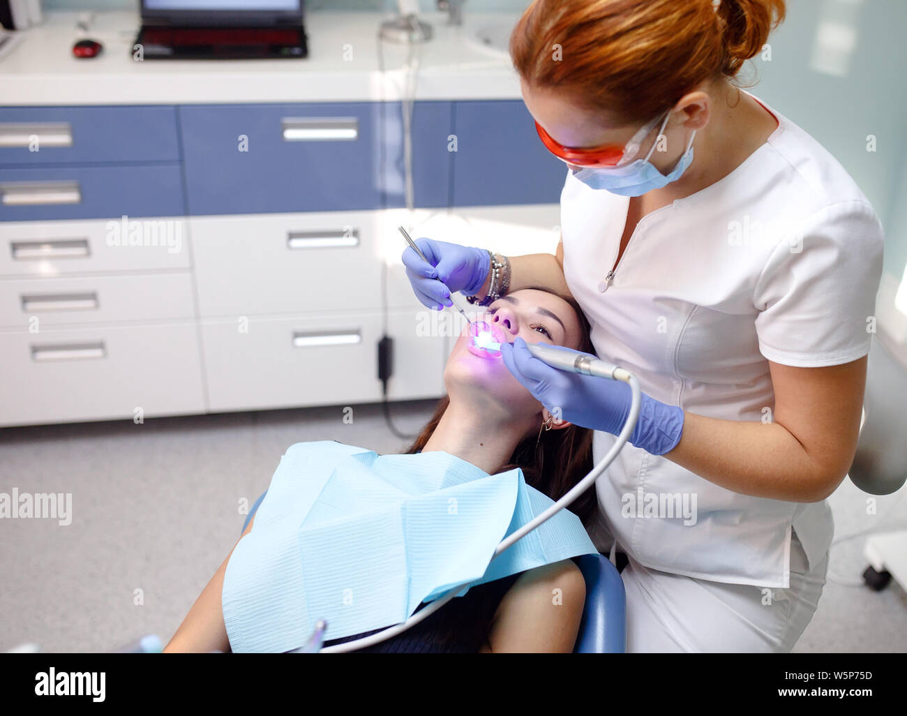 female dentist checking patient girl teeth in a clinic Stock Photo Alamy