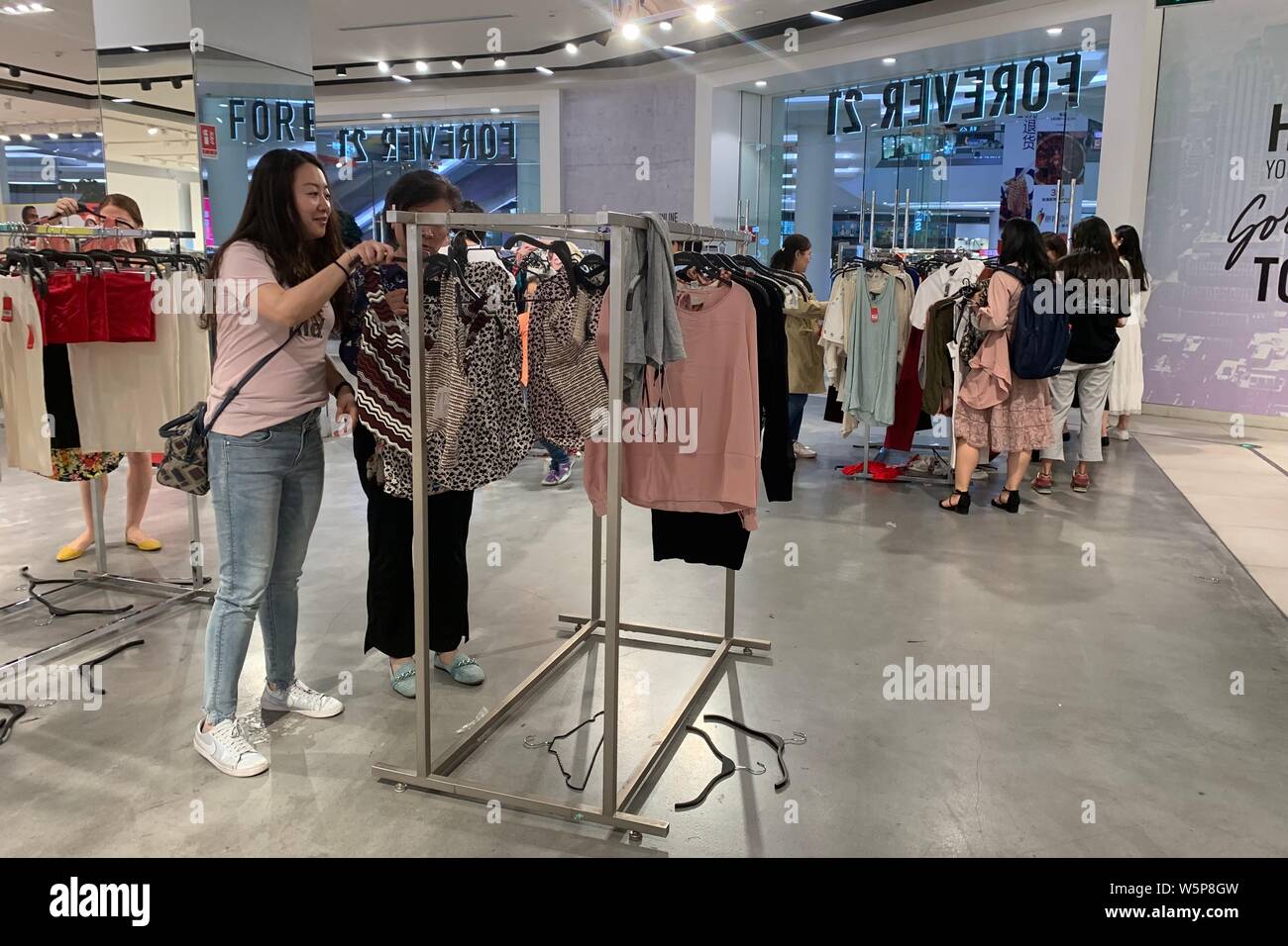 Customers shop at a store of Forever 21 to close down at a shopping mall in  Beijing, China, 20 May 2019. A growing number of foreign fast fashion br  Stock Photo - Alamy