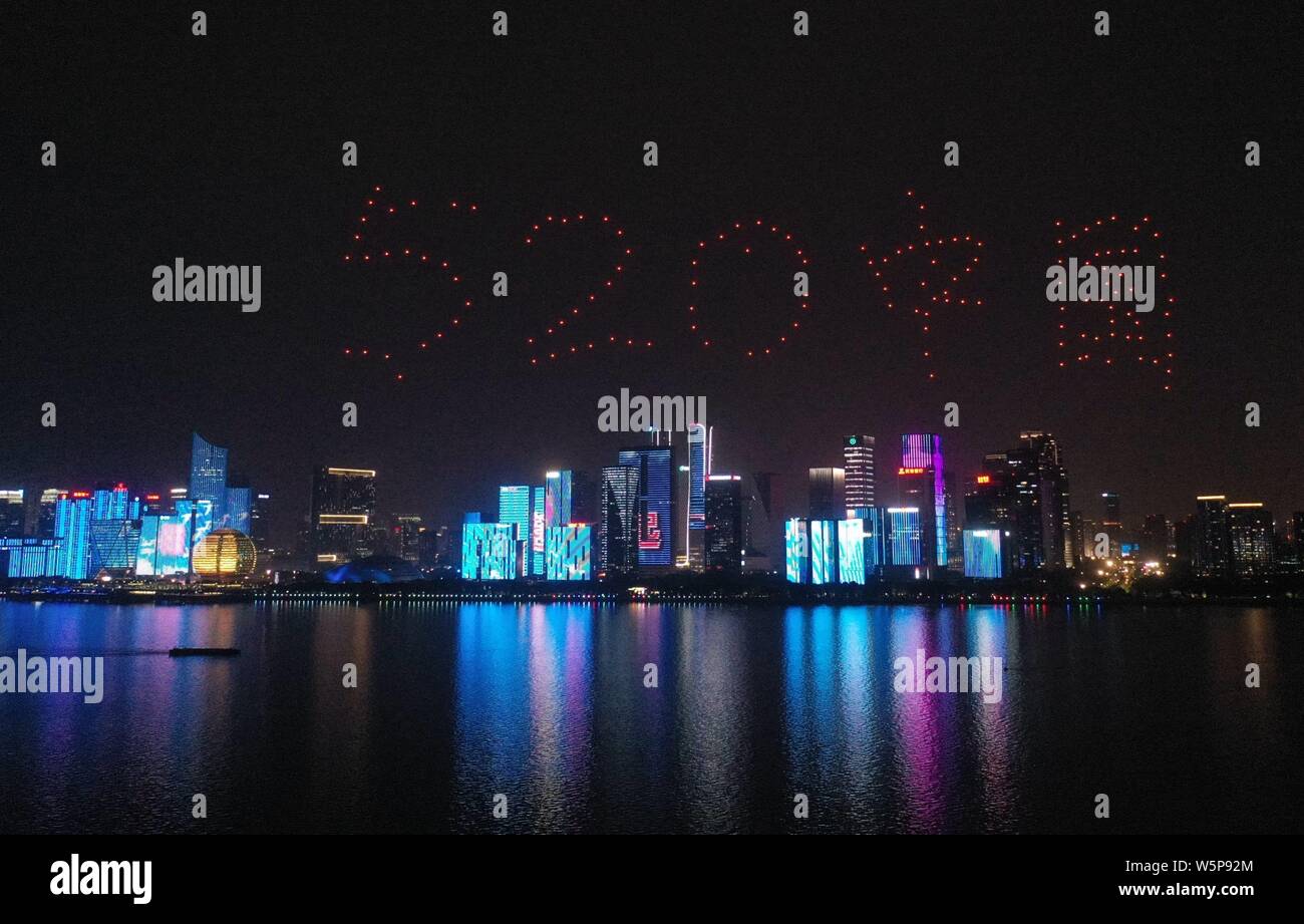 Drones or UAVs (unmanned aerial vehicles) are remote-controlled to form patterns of '520 China', which means 'I love you China' to mark the 70th anniv Stock Photo