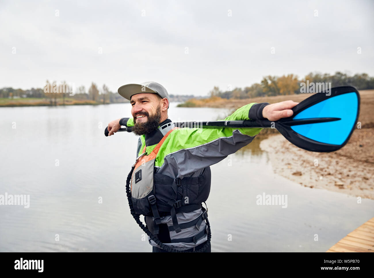 Portrait of bearded man in wetsuit on the beach Stock Photo