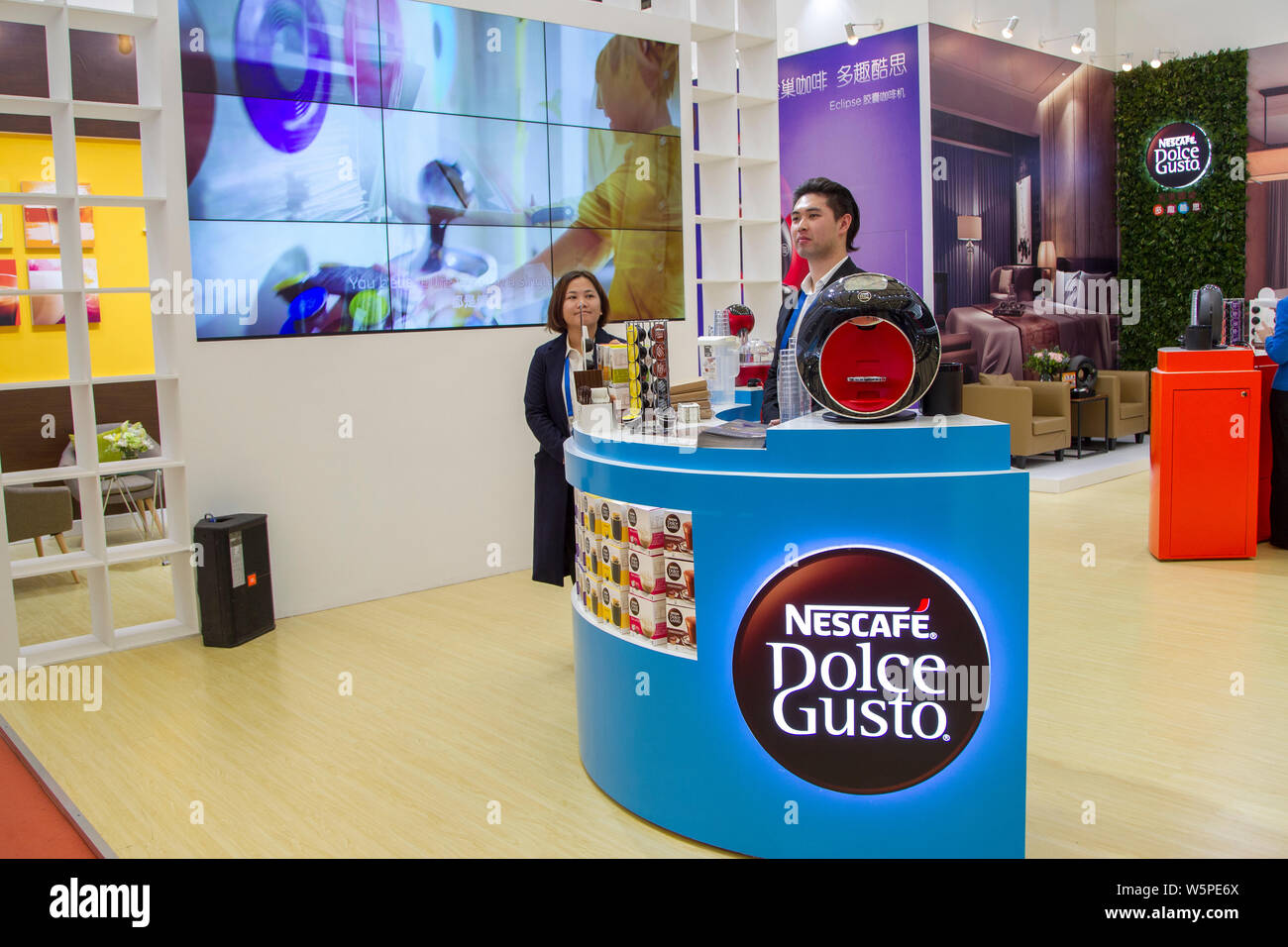 --FILE--People visit the stand of Nescafe instant coffee of Nestle during an exhibition in Shanghai, China, 1 April 2019.   Nestle has launched a seri Stock Photo