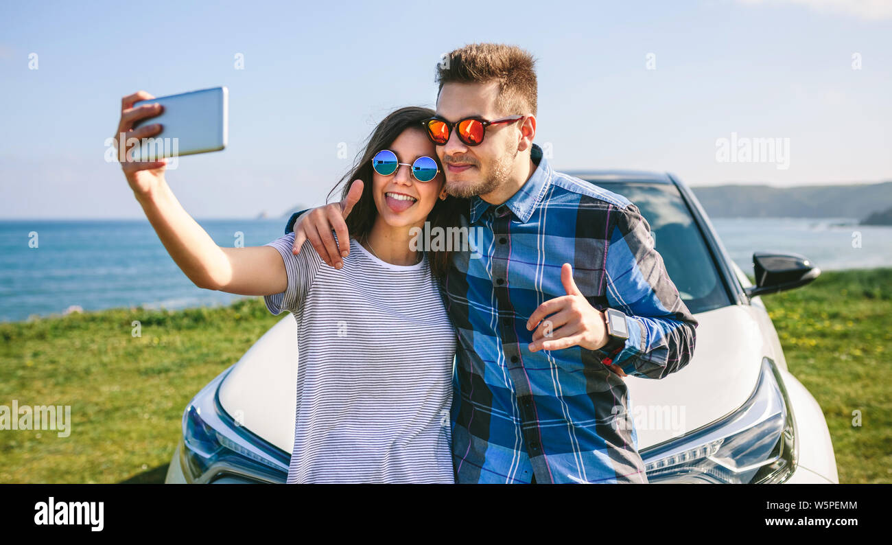 Young couple doing a selfie on the car Stock Photo