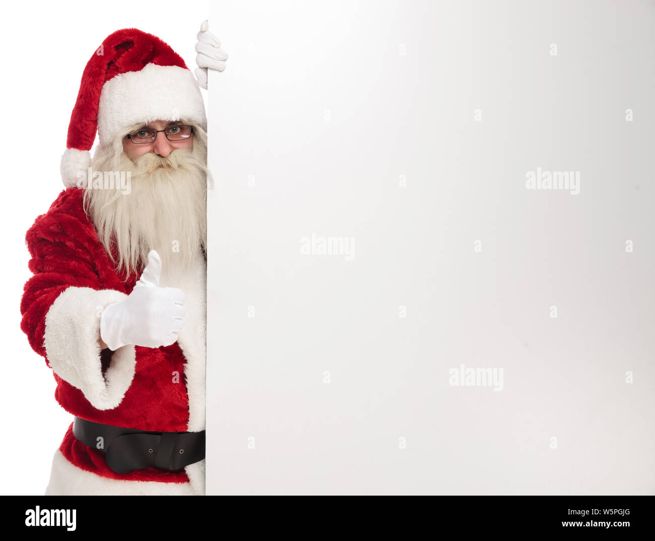 portrait of santa claus holding white empty board and making ok sign ...
