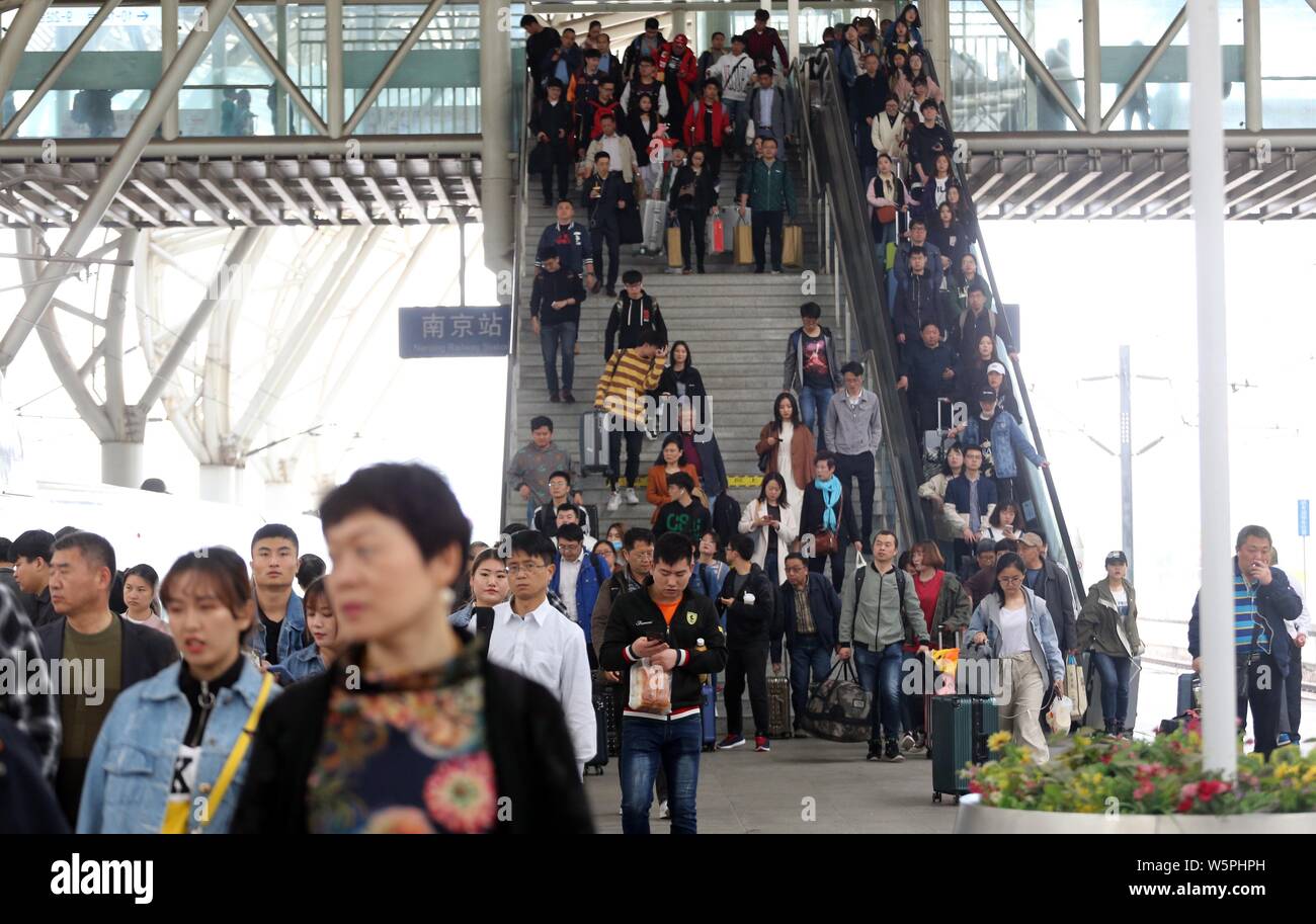 Passengers board their trains during the four-day May Day or Labor Day holiday at the Nanjing railway station in Nanjing city, east China's Jiangsu pr Stock Photo