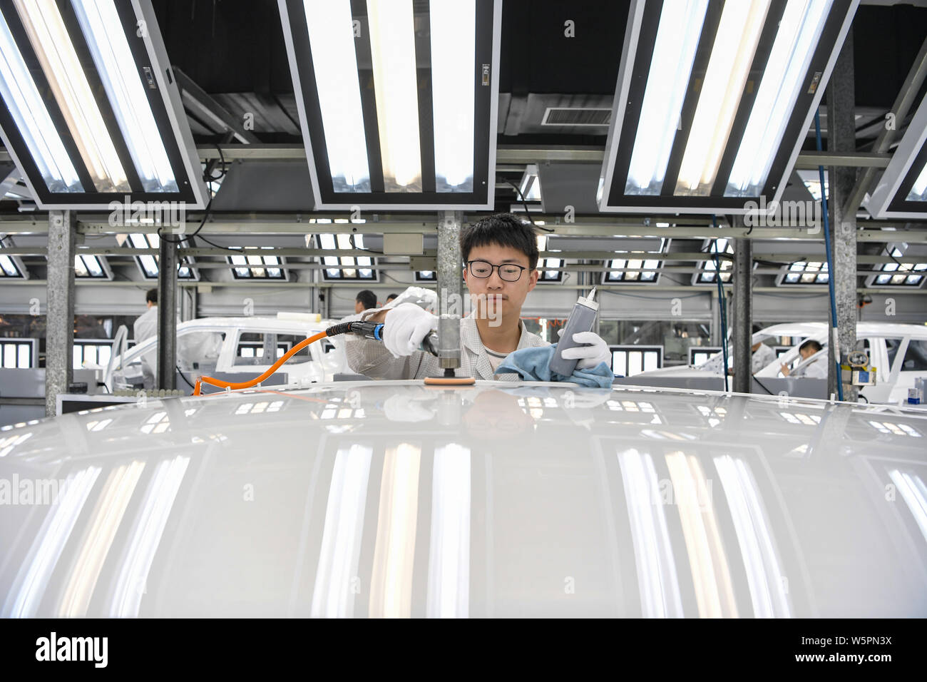 A Chinese worker assembles vehicles on the assembly line at the auto ...