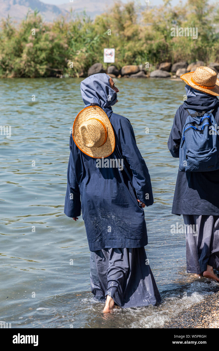 Tabgha, Israel - May 18 2019 : Nuns visiting the shore of Sea of Galilee in Tabgha church Stock Photo