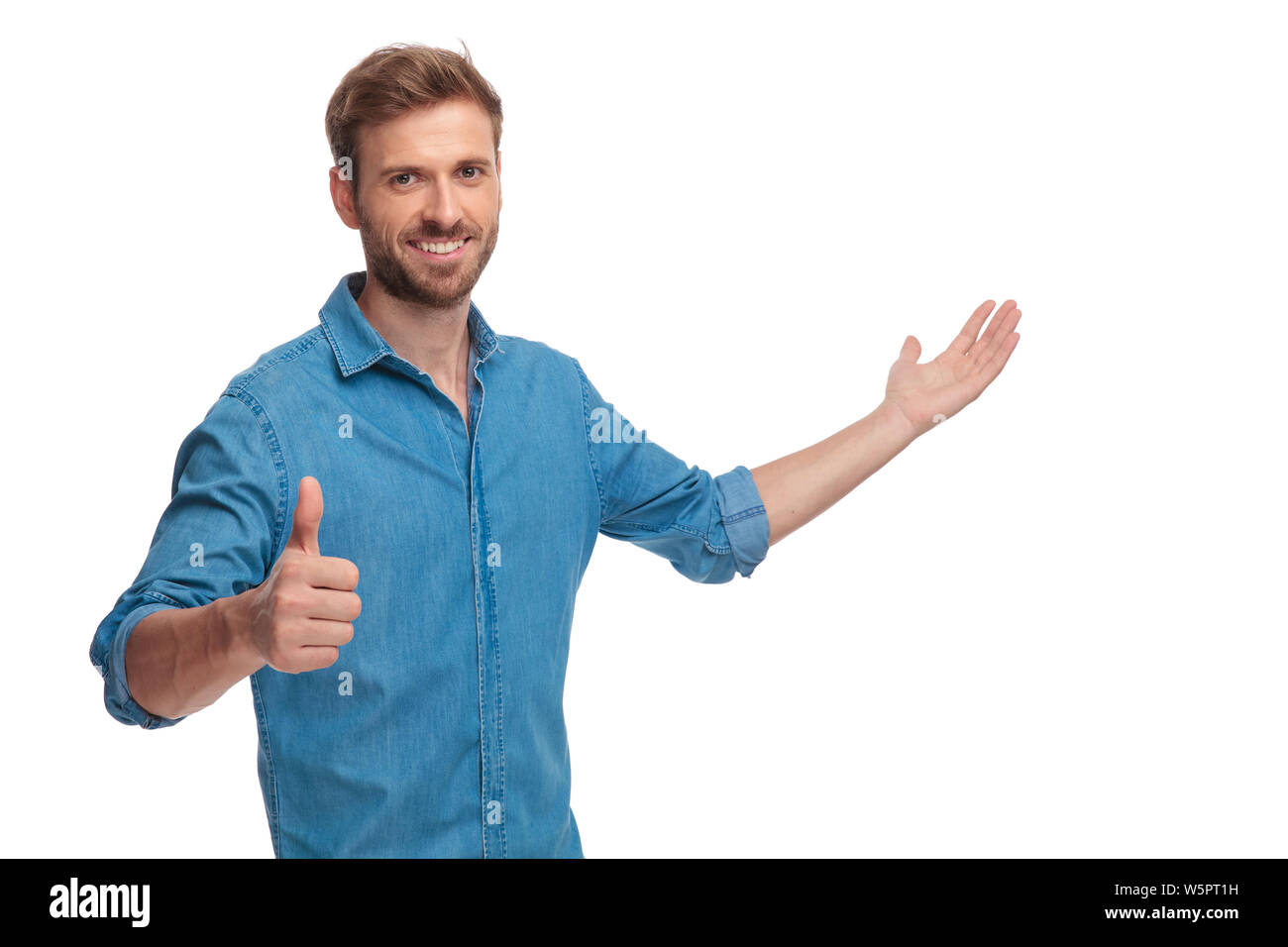 smiling young casual man presenting and making the ok sign on white ...