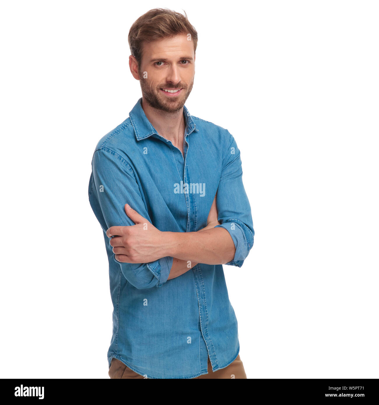 confident young casual man with arms folded, smiling on white ...