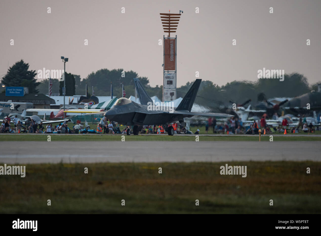 U.S. Air Force Maj. Paul Lopez, F-22 Demo Team commander, lands the Raptor after performing a twilight demonstration at EAA AirVenture in Oshkosh, Wis., July 28, 2019. With over 500,000 spectators in attendance and 10,000 aircraft on display, Oshkosh holds the title at the largest air show in the world. (U.S. Air Force photo by 2nd Lt. Samuel Eckholm) Stock Photo
