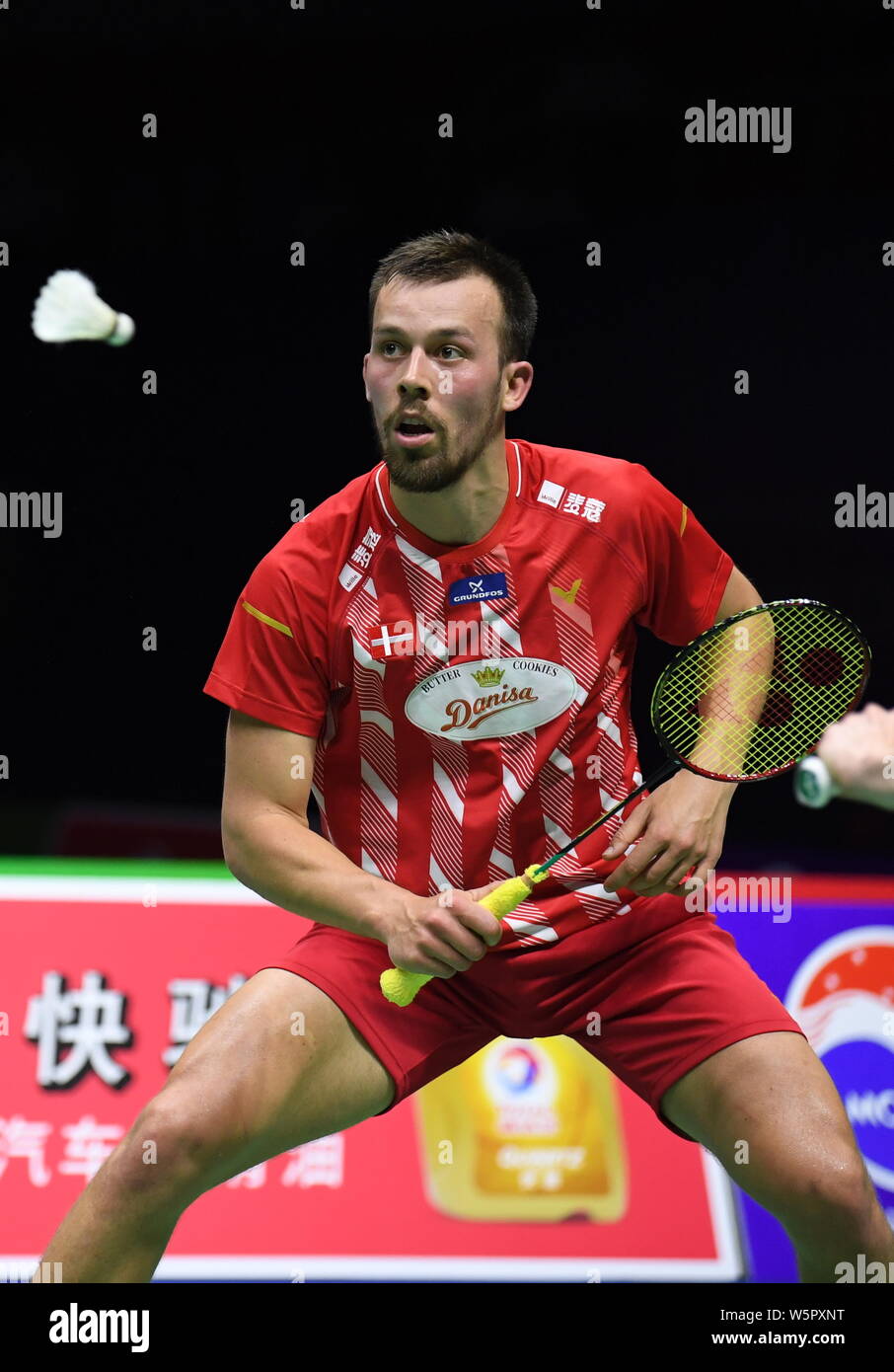 Anders Skaarup Rasmussen of Denmark returns a shot to Li Junhui and Liu  Yuchen of China in their group 1 match of Men's Doubles during the TOTAL  BWF S Stock Photo - Alamy