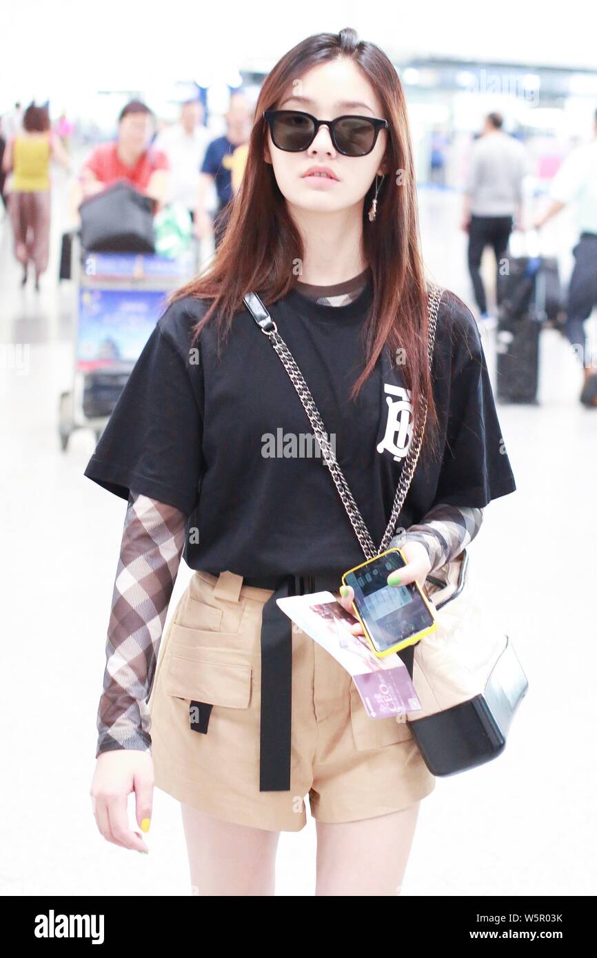 Chinese actress Jelly Lin or Lin Yun arrives at the Beijing Capital International Airport before departure in Beijing, China, 22 May 2019.   T-shirt: Stock Photo