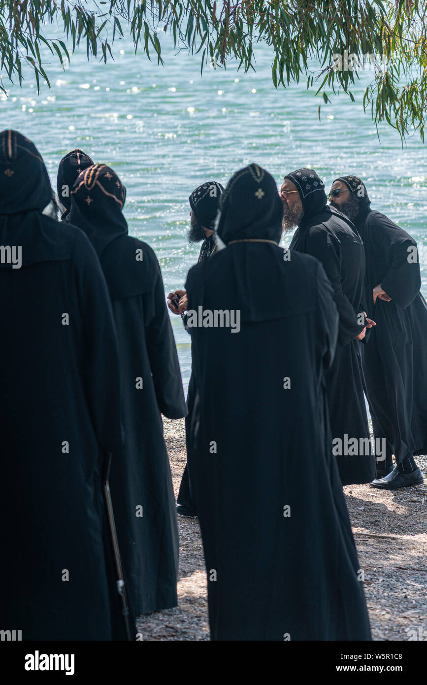 Tabgha, Israel - May 18 2019 : Coptic monks visiting the shore of Sea of Galilee in Tabgha church Stock Photo
