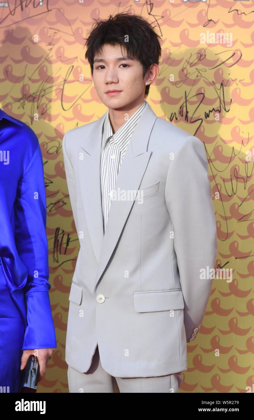Roy Wang or Wang Yuan of Chinese boy group TFBoys poses as he arrives ...