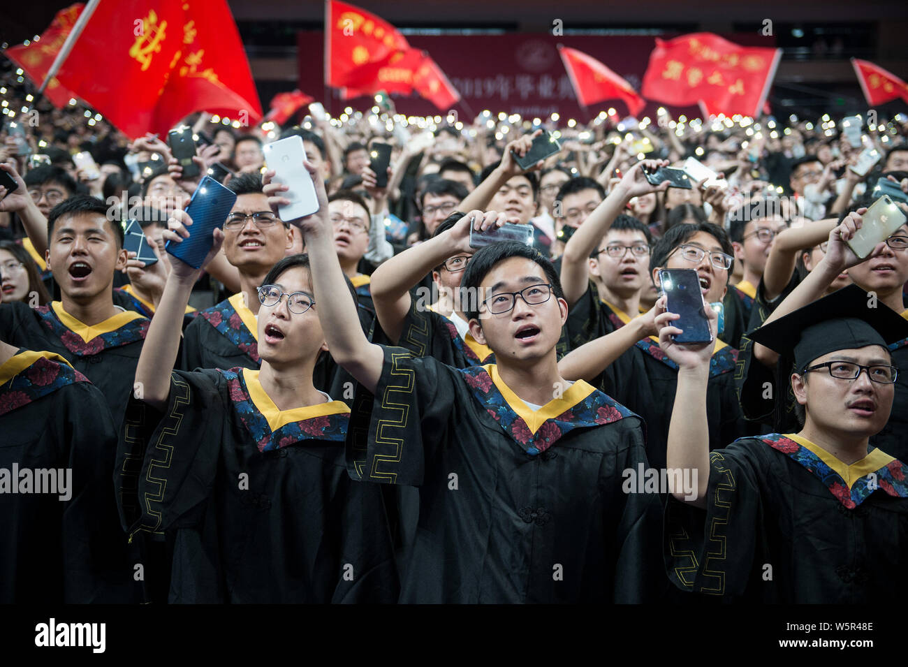 Undergraduates dressed in academic gowns take part in a graduation ...