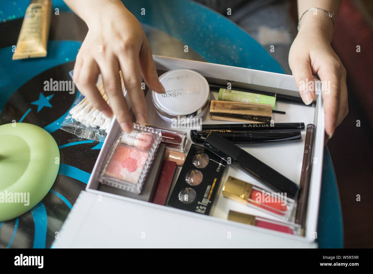 Chinese Worker Wu Demei Who Works On A Factory Selling Refrigerators For Cosmetics Sorts Out Her Makeup Products At Home In Ningbo City East China Stock Photo Alamy