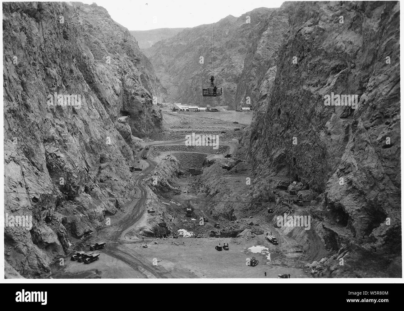Looking upstream through foundation excavation at dam site and power plant location. View from suspension bridge at outlet valve house benches.; Scope and content:  Photograph from Volume Two of a series of photo albums documenting the construction of Hoover Dam, Boulder City, Nevada. Stock Photo
