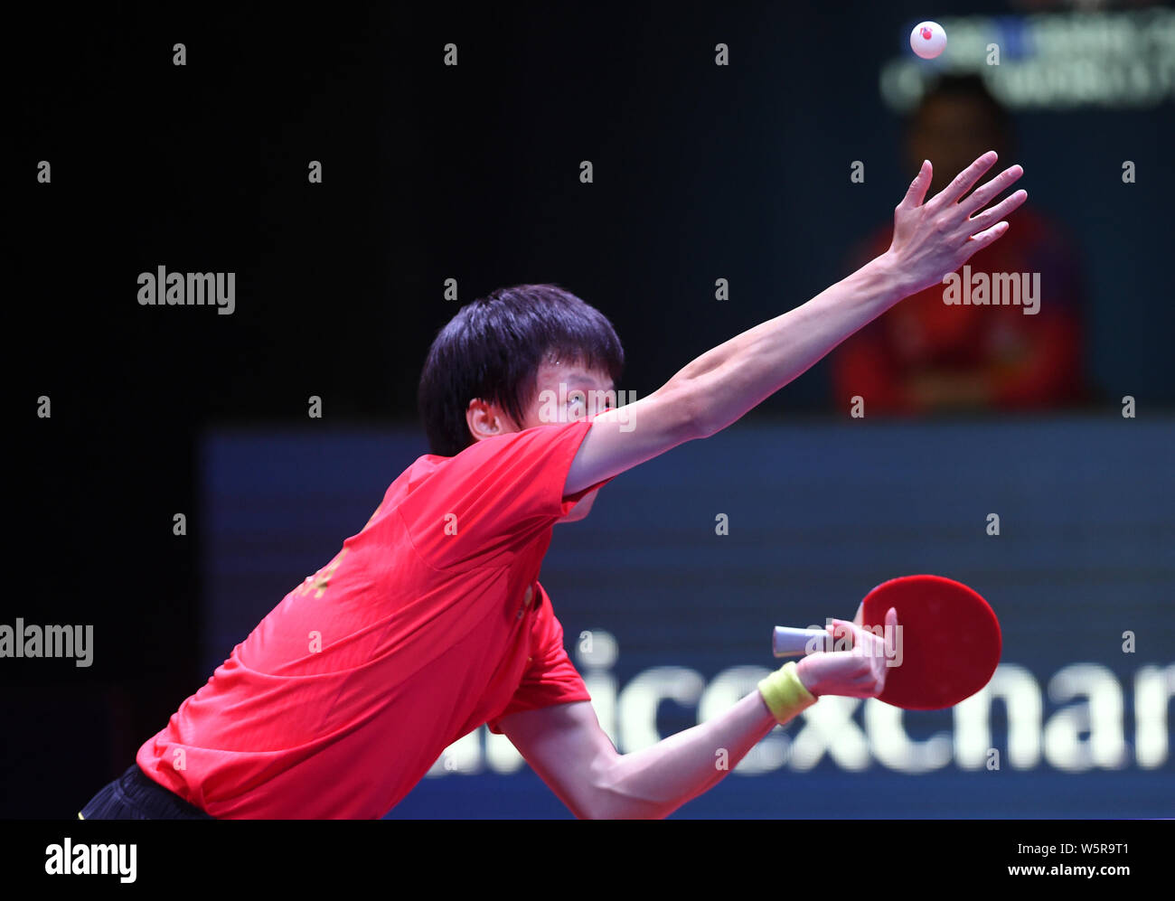 Lin Gaoyuan of China serves against Tomokazu Harimoto of Japan in the